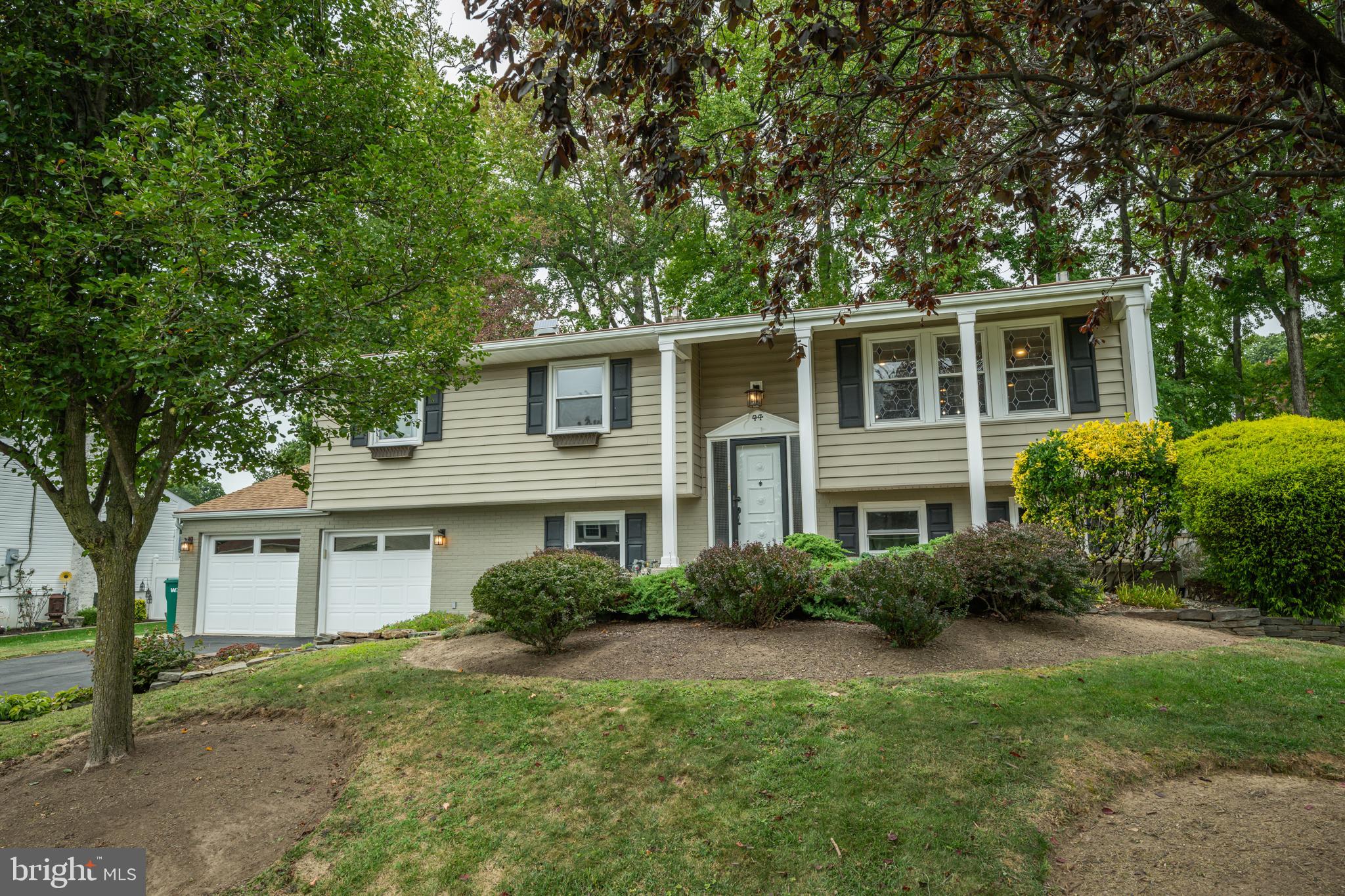Welcome home to this STUNNING 4 bedroom home located in the highly desirable Hedgerow Woods community of Falls Twp. Boasting modern upgrades and versatile living space this home offers the perfect blend of style, comfort and functionality. A private pathway guides you through manicured landscaping to your front entryway. Step into your welcoming foyer, graced by an elegant Tiffany-style chandelier, and be greeted by the warmth of original solid oak hardwood flooring that extends throughout the main level. Take a few steps up to your bright and spacious living room, highlighted by an oversized window with stained glass accents and large ceiling fan. The open layout offers a seamless transition from the living room into your stunning kitchen, designed with an industrial-chic flair. A true culinary enthusiast’s dream, your kitchen features a striking corrugated metal backsplash, upgraded LG stainless steel appliances and Yorktowne custom cabinetry with soft-close drawers. The expansive island is accented by pendant lighting and provides generous counter space and a large, deep sink for convenience. A separate dining area offers additional prep space/work space with an oversized window that frames beautiful views of your backyard. Continue down the hall, past two linen closets, to three spacious bedrooms and a beautifully upgraded full hallway bathroom showcasing a floor to ceiling tiled stall shower with glass doors and a sleek vessel sink, adding an element of modern design. Your primary bedroom suite boasts dual closets AND an ensuite full bathroom, recently renovated to perfection and thoughtfully designed with a stunning tiled stall shower with sliding glass doors and a luxurious rain-style showerhead. Step downstairs to your lower level family room, ideal for social gatherings, featuring a decorative fireplace, convenient powder room and direct access to your backyard deck – perfect for indoor/outdoor entertainment! Off the family room is a versatile 4th bedroom that can double as an office, playroom or even gym! Additionally, this floor offers direct access to your attached 2 car garage and features a HUGE cedar closet with built in organization. A laundry/utility closet with updated GE Profile graphite grey matching washer & dryer and bonus sink complete this floor. Step outside to your backyard retreat where your Trex patio with pergola creates the perfect setting for morning coffee or evening gatherings. An impressive large stone border frames the yard while lush, mature landscaping provides both beauty and privacy. A bonus shed offers ample storage for all your outdoor tools and essentials. Other recent upgrades include newer roof and siding, newer HVAC, newer water heater, Andersen Replacement Windows throughout the house with Hunter custom blinds AND gutter guards! This home offers an expansive driveway and oversized two car garage (with dedicated storage closets) for ample parking. Ideally located close to a variety of shopping and restaurants yet near Yardley Train Station with service to Center City, RT 1 and I 295 for easy commuting! Pennsbury School District too! Don’t miss your opportunity to see this beautiful home today! **Seller is also including a one year home warranty to the future buyer**