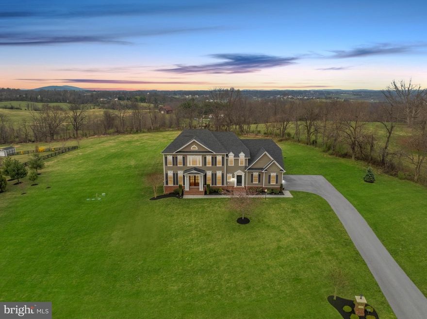 The perfect 10 home for sale in Purcellville, VA! This amazing semi -custom built home by Carrington  Builders is the Kendal Lane Model offering over 6000 sq ft of luxury finishes inside and out. Set on 3.11 acres in sought after Black Oak Ridge this home offers luxury finishes like  9' Mahogany double front doors and Hardi-plank exterior siding to exquisite trim detail  and wide plank engineered wood flooring. Loaded with options like 10' ceilings on the main level, coffered ceiling in the family room,  the keeping / sunroom off the kitchen, the extended kitchen counter and cabinetry for storage. A large island and private Trex deck overlooking the beautiful Blue Ridge Mountains. The spacious gourmet kitchen has  Island seating,   double ovens, cooktop with hooded vent,  a  built in microwave, a side coffee cocktail bar,  Arched wall accents lend an open but cozy feeling to the kitchen and family room space.    There is a main level office, a spacious living room, and separate dining room with beautiful trim detail. Tall transom windows bring in loads of natural lighting.   The  mudroom area off the kitchen  has a  a large pantry closet, a  washer/ dryer space and back staircase for easy access. The Upper level has hard woods in the hallway.  A primary suite that  features a cozy  sitting room and tall  palladian style  windows looking over the mountains. 2  large walk in closets. plus a  linen closet.  A spa bathroom with a separate soaking tub and 2  extra long vanities, A walk-in shower with 2 shower heads, 2 tiled inlay shampoo shelves and  2 bench seats. There are 3 additional bedrooms- an Ensuite bedroom (with a private bath) and 2 bedrooms that share a Jack and Jill bath.  The lower level is fully finished with a 5th bedroom and full bath - perfect for guests. A walk out door to the yard.  A huge recreation room with a pool table and entertainment space with wired surround sound. A wet bar rough in for  adding a future bar and a hobby / bonus room. The back yard is very open yet lined  in back with trees for a private feeling.  Newly installed water filtration system.  High speed internet. 3 Car side load garage with additional space for storage.  This home is a must see  home, very well maintained.