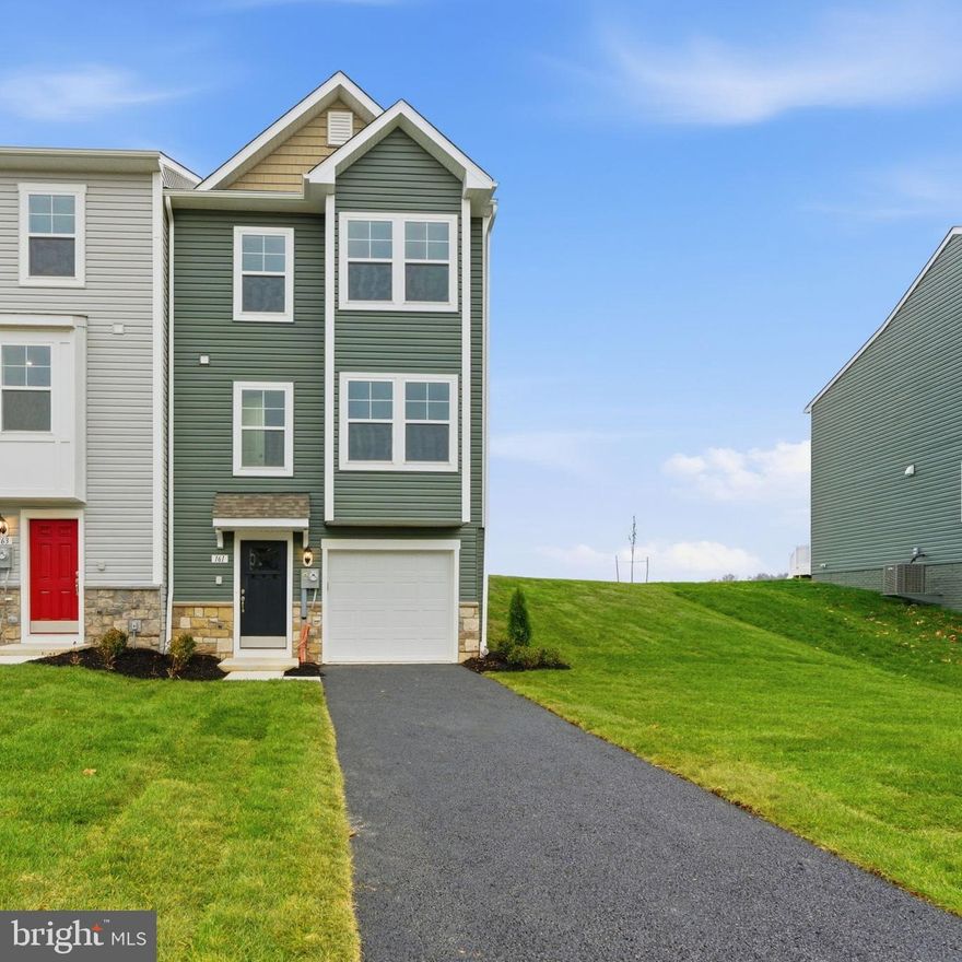 **OFFERING UP TO $18K IN CLOSING COST ASSISTANCE FOR PRIMARY RESIDENCE WITH USE OF APPROVED LENDER AND TITLE**
END HOME - MOVE-IN READY! Over 1,890 finished sq. ft. This is last brand new York Garage with morning room addition (8' x 12' extension on all three levels) with Gray kitchen/bath cabinets WITH A SOAKING TUB and separate STEP IN SHOWER in the primary bath!

This townhome that backs to open farmland and beautiful sunsets. Outside find one of our longest asphalt driveways over 45 ft! Front yard is fully sodded and charming landscaping package welcomes your guests. This home features a double turned gable roofline with algae resistant architectural shingles. Forest Green siding is accented by a cobblestone water table. An impressive 2 level box bay window that bumps out bedroom 2 and the family room. This home includes a drywalled garage with a Wi-Fi enabled garage door opener, 2 remotes and a convenient outdoor keypad. Garage is angled to allow you to open a car door easily when parked in the garage. Front of home features 6 windows that will allow the morning sun to light up the family room and secondary bedrooms. Step inside to waterproof luxury vinyl plank flooring and a large coat closet with a built in low-voltage media cabinet ready for your internet router. Follow the foyer back to the large finished basement with 2 separate storage closets (1 has rough in for a future powder room). The finished recreation room is two areas large enough for multiuse media room, playroom, office, overflow guest space or fitness area and offers plenty of storage for your home.

Head back to the foyer and climb the 40"wide steps up to the main level. The main level offers a feast for your eyes. The kitchen takes center stage with full overlay 42" upper raised panel gray cabinets reach all the way to the ceiling. The cabinets are accented by Satin nickel rounded pulls, Artic Stainless Gooseneck kitchen faucet with pull down sprayer, and 3 pendants lights featuring vintage-inspired brushed nickel metal fittings with industrial styling featuring an oversized warehouse shade fabricated from clear glass. Stainless Whirlpool 4 burner electric range featuring 2 dual radiant burners. Side by side 25 cu. ft., 36" wide refrigerator with filter water and ice dispensing offers frameless glass shelves, can caddy and fingerprint resistant stainless finish. Sensor microwave with electronic touch controls offers built in externally vented fan to clear away cooking odors. Stainless interior/exterior dishwasher features pocket handle and quiet boost cycle. Stainless single bowl undermount sink has in-sink garbage disposal for easy clean up. The star of the kitchen is the 8.5 quartz prep island that offers room for 4 counter height bar stools. The Lyra quartz countertop is a soft white coloration with fluid movement of shades of gray and faint light brown speckling.

The family room with a box bay window perfect for a window bench or shelving for your favorite plants. Family room includes 4 LED low profile long lasting lights and ceiling fan pre-wire. Prewire for cable and data is located at the center of the family room wall. Powder room for main level is located at front of home. The family room will hold a generous sectional and coffee table. As you walk to the back of the home you will take in a view from the morning room as you walk out to the 8x8 composite deck and the private back yard view. It is here that you will enjoy sunset views and and the quiet solitude of cornfields swaying in the breeze. Your deck includes a 6x 8 privacy panel that separates you from your neighbors while enjoying the view. Add a low maintenance patio for additional entertaining or grilling area. Upstairs the primary suite that easily accommodates a king sized bed and dresser.