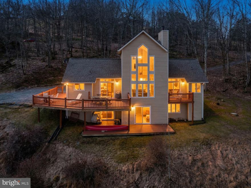 Experience mountain living at its finest in this breathtaking mountaintop home overlooking Deep Creek Lake. With sweeping views from almost every room, your hardest decision may be where to sit to enjoy them. Offering three levels of living space, hardwood floors ( which were recently refinished), and some new appliances. The multiple decks are ideal to enjoy family and friends while taking in the beauty around you. The location is another plus, just minutes to the community club house where you can enjoy the lake, and minutes to Wisp Ski & Golf Resort, restaurants, coffee shops, cinemas, and grocery stores. Class A lake access. Call today to preview!