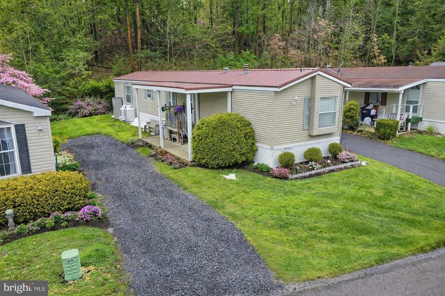 True one‑level living awaits in the quiet & friendly Lynn Wood Hills Mobile Home Park. This peaceful community sits just minutes from town conveniences & only 1.3 miles from the West Branch of the Susquehanna River, an ideal spot for fishing, kayaking, or simply enjoying the view. It’s a serene bonus that adds to the charm of this welcoming neighborhood.  Whether you're looking to downsize or purchase your first home, this property offers an affordable opportunity with plenty of potential to make it your own. Exterior highlights include off‑street parking, a covered patio perfect for morning coffee & a manageable lot that balances privacy with accessibility.  Inside, you’ll appreciate the vaulted ceilings & sun‑filled open concept layout. The spacious living room provides a comfortable gathering space, while the light & bright kitchen features a cheerful dining area, included appliances, ample cabinetry & generous countertop space for meal prep. A convenient laundry room with an included washer & dryer adds everyday ease.  The primary bedroom offers a private full bathroom complete with a corner soaking tub & separate shower. Down the hall, you’ll find two additional bedrooms & another full bathroom, providing flexible space for guests, hobbies, or a home office.  Additional amenities include propane forced air heat & a new metal roof (2023).  Lot rent is $260/month and includes exterior maintenance, road upkeep & snow removal on public roads. All buyers must be approved by Lynn Wood Hills Park Management.  Schedule your private showing today & discover the comfort, convenience & value this home has to offer.