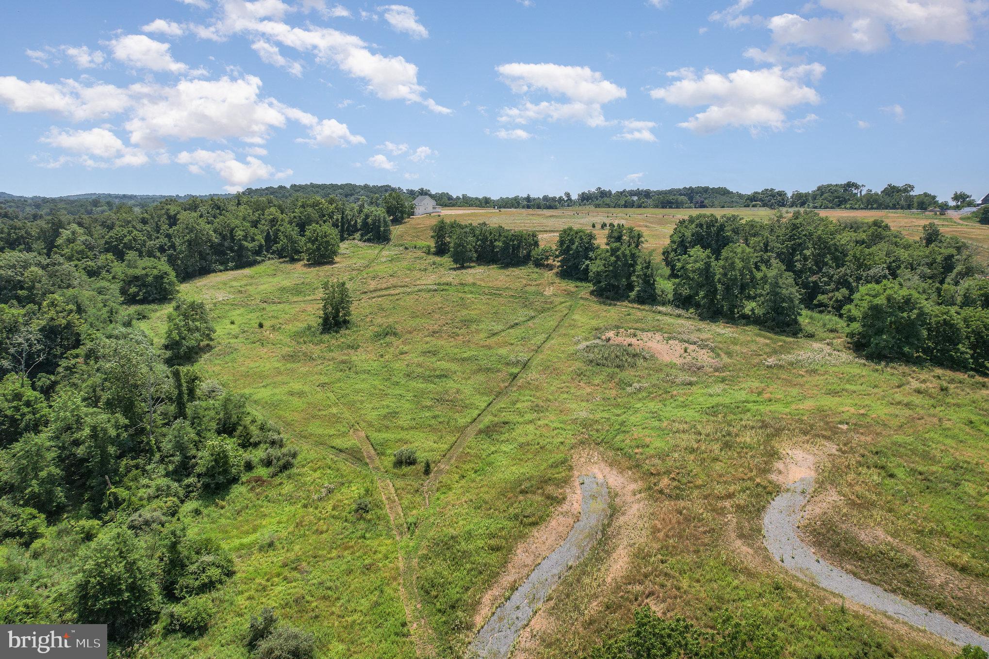 Don’t miss one of the last remaining chances to secure a truly special setting at Mowery Orchards. Lots 18 and 19 are being offered together, creating a rare 6-acre private estate enclave tucked among mature trees and bordered by 54 acres of preserved open space.
This remarkable homesite offers direct access to a scenic 1-mile loop walking trail that winds along Pippin Run—perfect for peaceful morning strolls or nature-filled afternoons.
Design and build your dream home with Tru Construction, partnering with a dedicated personal designer to bring your vision to life. This is more than just a place to live—it’s a lifestyle defined by privacy, natural beauty, and custom craftsmanship.