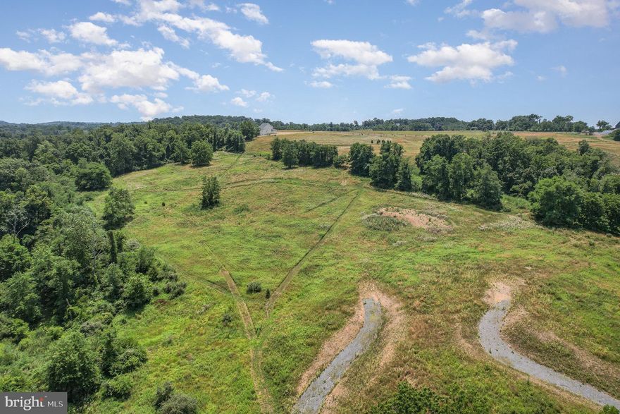 Don’t miss one of the last remaining chances to secure a truly special setting at Mowery Orchards. Lots 18 and 19 are being offered together, creating a rare 6-acre private estate enclave tucked among mature trees and bordered by 54 acres of preserved open space.

This remarkable homesite offers direct access to a scenic 1-mile loop walking trail that winds along Pippin Run—perfect for peaceful morning strolls or nature-filled afternoons.

Design and build your dream home with Tru Construction, partnering with a dedicated personal designer to bring your vision to life. This is more than just a place to live—it’s a lifestyle defined by privacy, natural beauty, and custom craftsmanship.