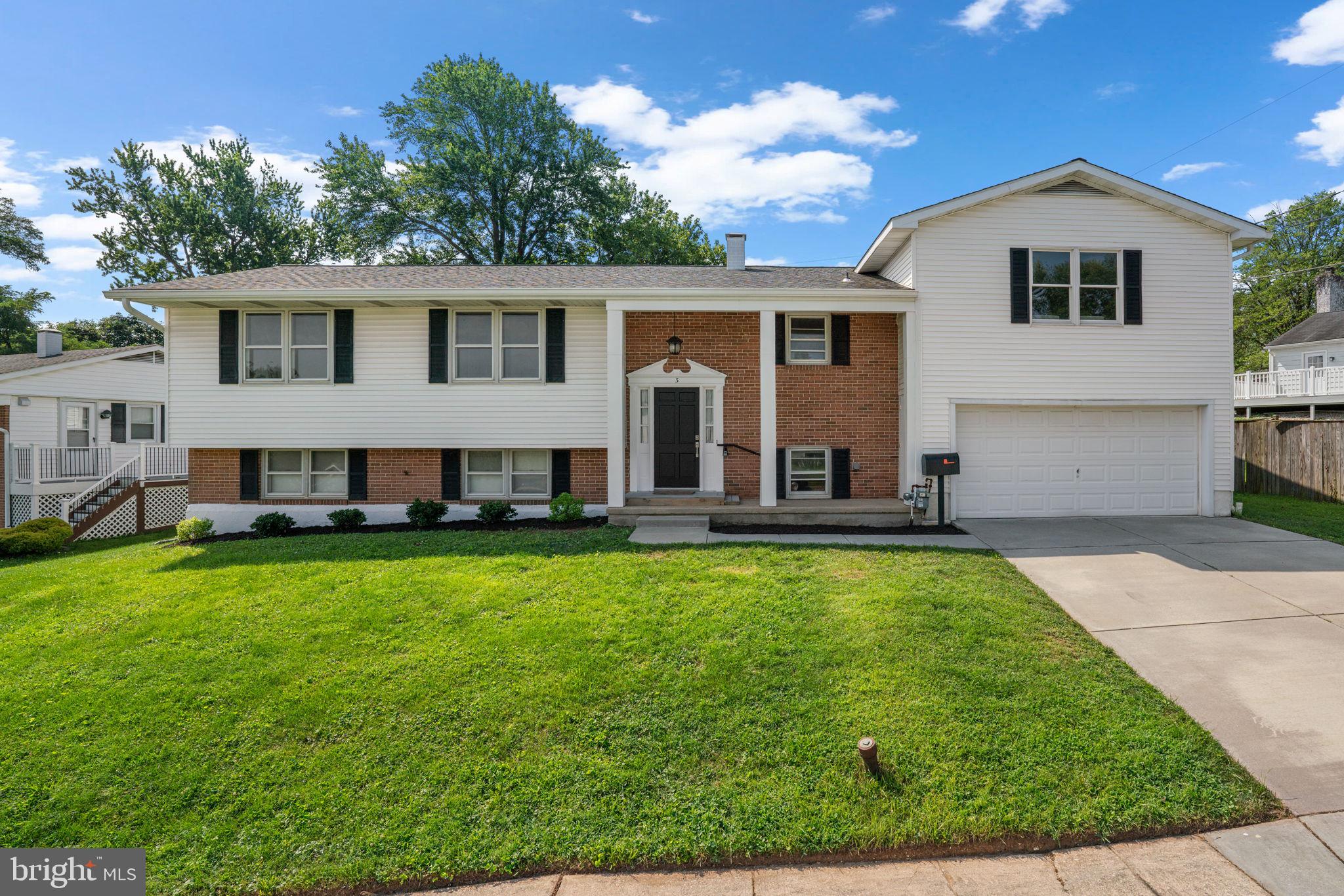 Freshly updated split-foyer residence offering 2,312 square feet, 3 bedrooms, 2 full bathrooms, 1 half bath, and a 2-car garage, ideally situated in charming Ridgefield. A welcoming front porch with classic columns leads into the foyer, where stairs ascend to a bright and beautifully appointed main level. The sunny living room flows seamlessly into the adjacent dining room, creating an open and inviting atmosphere. Just a few steps up, an expansive family room awaits, featuring a full wall of built-in bookcases that add both warmth and character. Back on the main level, the bright white eat-in kitchen offers a clean, airy feel with white cabinetry, stainless steel appliances, and a pass-through window that enhances the open layout and makes the space feel especially cozy and connected. The home includes three generously sized bedrooms, including a spacious primary suite with an en suite bathroom, and a second full bath that serves the additional bedrooms. The finished walk-out lower level offers flexible additional living space, including a convenient powder room and a utility room with laundry. Outside, enjoy the private, fenced backyard with a patio for entertaining, a storage shed for added convenience, and plenty of room to relax or play. Recent updates include: Kitchen with new premium appliances and countertops (2025), Bathrooms (2025), Interior Paint (2025), Carpet (2025), Roof & HVAC.
The basement can support the addition of 2 additional bedrooms.
Don't miss this one!!