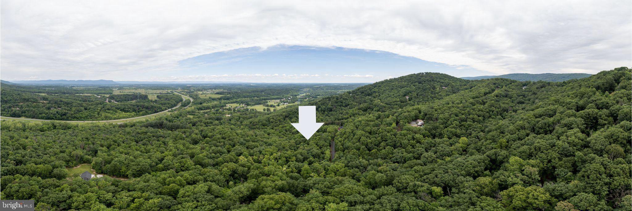 Imagine building your perfect home or tranquil retreat on this ready-to-go 3-acre lot in Apple Mountain West. What truly sets this property apart are the pre-approved conventional septic and well permits for a 4-bedroom home, which are fully transferable to you. This means significantly less red tape and a much smoother path to breaking ground on your permanent residence or peaceful vacation escape.
Access is a breeze, with a paved road leading directly to the property. You'll find yourself surrounded by a beautifully wooded, natural mountain setting characteristic of this desirable area. The lot also backs up to a larger wooded area, giving you an enhanced sense of privacy and seclusion.
For the outdoor enthusiast, this location is a dream come true. You'll be moments from Shenandoah National Park and George Washington National Forest, opening up endless possibilities for hiking, tubing down the Shenandoah River, or simply soaking in the scenic views along Skyline Drive. Yet, despite its natural charm, you're only 8 miles from Front Royal's convenient shopping and dining, with easy access to I-66 for commuters.