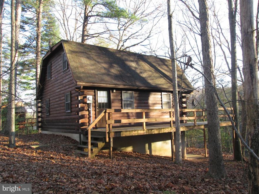 Waterfront on Sleepy Creek! Charming log home nestled in the trees on very private wooded lot with winter views. Home has been very well maintained & is move in ready. Features large living room with woodstove, main level bedroom & walk-out basement . Enjoy nature from the large deck. Most furniture conveys, seller will consider installing heating system with acceptable offer.