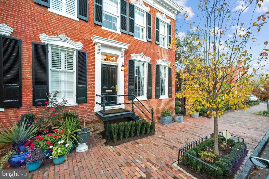 Exquisite semi-detached custom designed Federal home located in the East Village of Georgetown. This property was completely renovated in 2017 in collaboration with architect Christian Zapatka to create a new and expanded 2,850 total sq ft floor plan with top of the line finishes. The home includes a custom designed French Salon with formal living and dining area complete with Chesneys of England dual gas fireplace mantels surrounded by 24K gold-leaf accents.  The Kitchen showcases the finest Carrara marble, maple cabinetry and an expansive custom glass & stainless steel cabinet system along with an Officine Gullo 42 inch cast iron oven range.  Light-filled family room delivers eight true light French doors, coffered ceilings, radiant limestone flooring and entry to large garden with heated saltwater pool and cabana - perfect for outdoor entertaining.  4 total bedrooms, 3.5 bathrooms, French and reclaimed white oak flooring, custom silk carpets, silver and nickel plated hardware and a state of the art security systems.  Octagon master bath with black lacquered closets and black metal skylight over a nickel-plated British soaking tub. Gracious upper floor bedrooms with abundant light!  One of a kind floor to ceiling art filled picture window features lower level staircase leading to in-law suite with kitchenette.  Lower level complete with mirrored gym and extra storage closets. If needed, a dedicated garage parking spot has been secured for monthly rental.  Be sure to visit the 3D tour!