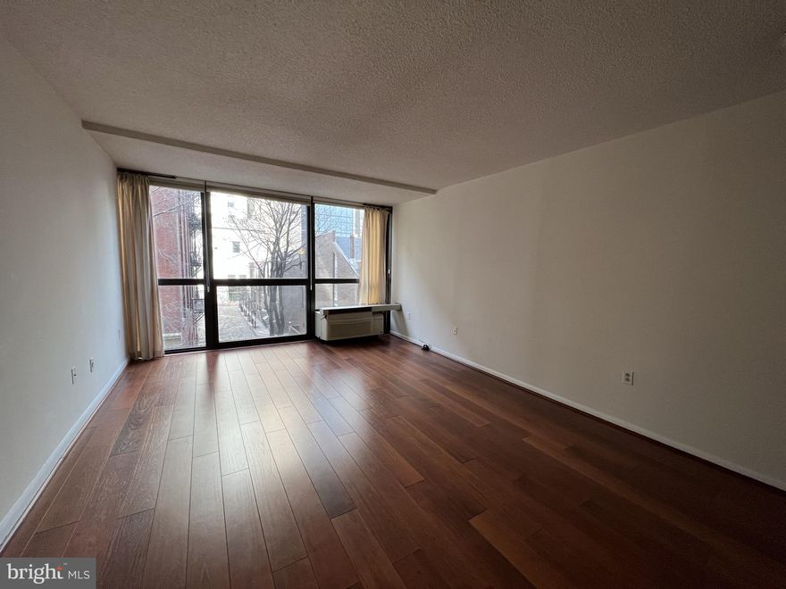 Spacious one bedroom, one bathroom with many tasteful updates throughout at Independence Place, Tower II! This sun-soaked home offers walls of floor-to-ceiling windows showcasing treetop views, vinyl floors, and ample entertaining space. Enter through a gallery foyer into the sun-soaked combined living and dining room. Open to the living area, there is a bright kitchen featuring white and black cabinetry, white countertops, white appliances and a breakfast bar. The spacious bedroom suite enjoys a walk-in closet and a large bathroom with an updated single vanity and shower/tub.  Additional home highlights include a stackable washer/dryer and great storage space. Residents of Independence Place enjoy a twenty-four hour doorman and concierge, a beautifully appointed lobby on the main level, on-site management, and individual heat & air conditioning controls. On-site garage parking is available for rent.