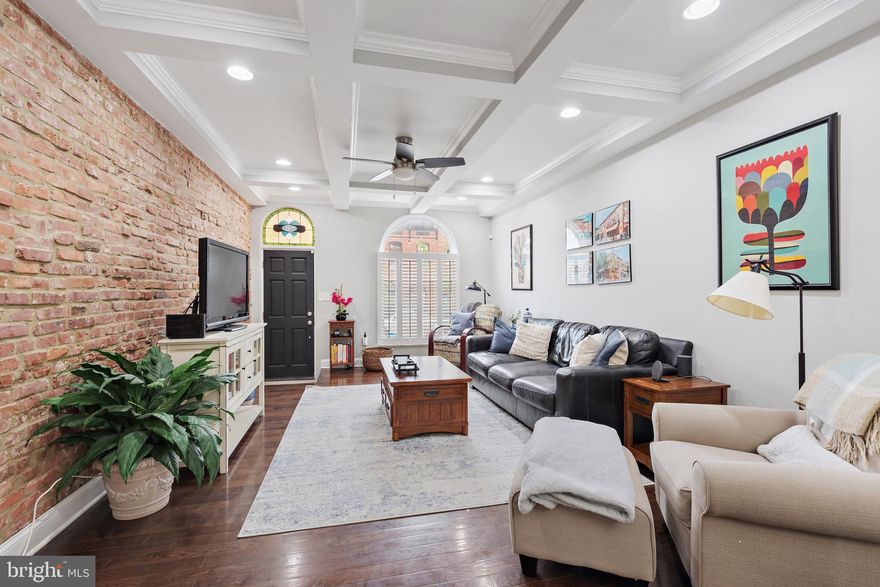 Gigantic 14 foot wide previous chap renovation now available on an extremely sought-after block. Parking pad out back & 2 tiered rooftop deck. Approximately 2 years remaining on the CHAP tax credit. Glistening hardwoods cascade throughout with tons of natural light. Enjoy your coffered ceilings, accent dining room wall, exposed brick and stained glass features on the main floor. In the designer chef's kitchen you will find high end white cabinetry, upgraded trim and paint, imported tile, granite countertops, upgraded stainless steel appliances and an oversized island. Off the kitchen there is a designated entrance for the parking pad with a conveniently located half bathroom. Upstairs you'll find two bedrooms, a large hall bathroom with his and hers showers, double vanity and jacuzzi tub. Off the rear bedroom you will access the two tiered rooftop deck with amazing views of Patterson Park, the Baltimore City Skyline and the Inner Harbor. The finished lower level includes an additional bedroom with high ceilings, full bathroom and laundry and storage room. Close proximity to retail shopping, local dining, Patterson Park and all major highways. Schedule a private tour today.