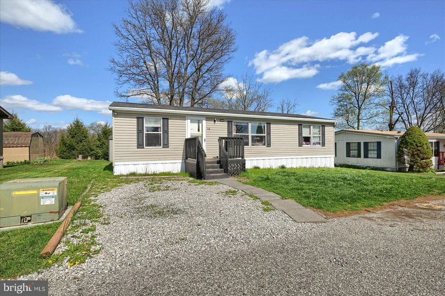 An excellent opportunity! This 2007 three-bedroom, two-bath double-wide home is priced to move! Yes, it needs some TLC, but you'll love the spacious open floor plan and the fantastic location on a lot that overlooks farm fields. The owner's suite is complete with a walk-in closet, corner soaking tub, separate shower, and double sinks. Plus, there's a smart split floorplan with two more bedrooms and a bath on the other side of the home.  This one won't last long!  Park ground rent is $580 plus charges for trash, sewer, and water based on usage.  Park requires a background check and credit report with a minimum 625 credit score for each adult.