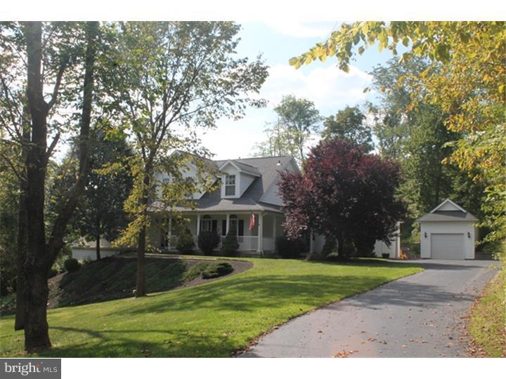 This expansive custom built Cape Cod home with dramatic wrap around porch is beautifully positioned in a secluded setting yet just a short walk along recreation path and sidewalks to the ball fields, playground and amenities of Warwick Community Park. With a screened porch, deck, and expansive paver patio.  This home features great outdoor living space and a natural wooded setting that is complemented with tastefully maintained and lush landscaping.  Upon entrance you are greeted with hardwood floors, neutral coloring and an open floor plan.  The great room boasts soaring vaulted ceilings, gas fireplace, custom built-ins, a wall of windows and an inviting custom window seat. The kitchen showcases 42" cabinets, Corian counter tops, center island and pantry. The breakfast room just off the kitchen is an extension into the cozy screened in porch.  The formal dining room offers a trey ceiling, extensive moldings and beautifully arched windows. The main suite has an abundance of closets, trey ceiling, sitting area and a walkout to the deck. The luxurious master bath has dual vanities, jetted tub, large tiled shower, and a universal design. A half bath with pedestal sink, hardwood floors and a designated laundry room with utility sink completes the first floor. The upper level has three additional bedrooms, all generous in size, plentiful closets and a shared hall bath with dual vanities and a universal design.  The lower level offers hardwood floors, a full over-sized bath, custom bar, french doors, 9 foot ceilings, large storage area, in home gym with mirrored walls and padded flooring. A two car attached garage with inside access and in addition, a one car detached garage.  Pride of ownership is apparent, meticulously cared for and maintained, neutral coloring, drenched with natural sun light and great for entertaining.  Centrally located to all major commuting highways such as New York, Philadelphia and New Jersey. Home priced below appraisal value. CBHIP Corporate Documents Apply.
