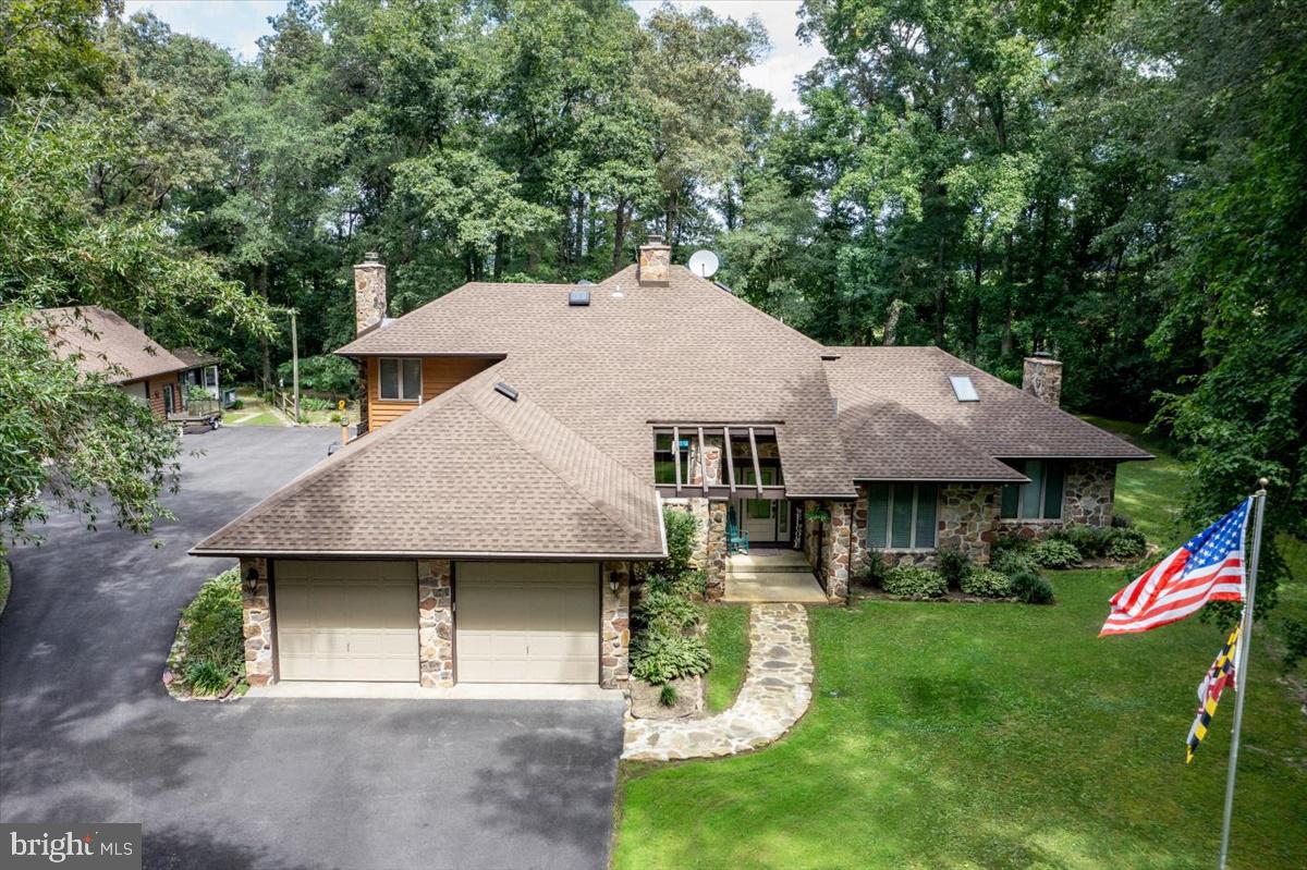 This dream house has everything you can imagine! From the moment you enter onto this 3.19 acre beautifully maintained property from the pristine driveway, until you see what's next, you will be in awe. Welcome home to the warmth of a large foyer coupled with a 2-story stone fireplace that guides you right into the lovely Living Room. The main level is perfect for someone would enjoy one-level living. It consists of of everything that’s needed; Dining area, Kitchen with a Breakfast Nook and large Pantry, Family Room with an enclosed Sunroom, Office/Study, Laundry Room, and Primary Bedroom Suite with its large walk-in closet and expansive bath and enclosed Sunroom. Yes, there are 2 beautiful sunrooms on the main level. The upper level has 2 nicely appointed bedrooms, each with its own walk-in closet, a full bath, and the large Loft that overlooks below! It also has a neat laundry shoot!
Now, there’s more! Lots more! There’s a detached garage that’s currently being used as a “Man Cave”, but has so many possibilities. There’s a “She Shed” that also has unlimited possibilities. I was told that the previous owners had a business. You will have to let your mind wonder! Don’t think too hard, just sit by the pool and come up with your future plans for this property. Make your plans to visit today!