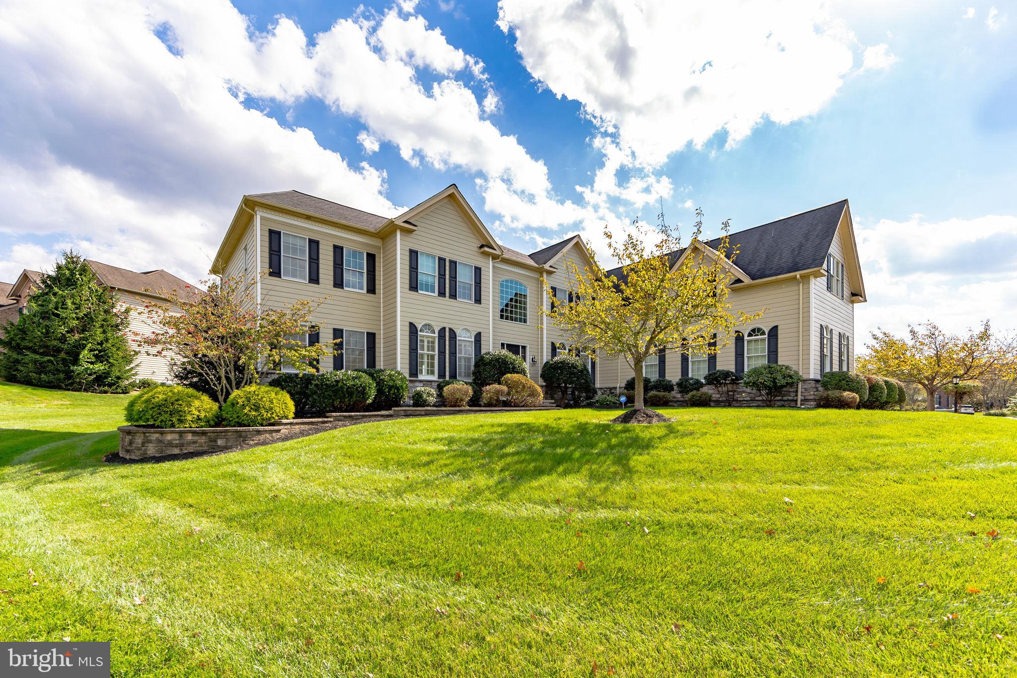 The Belle of the Ball in Byers Station / Downingtown East Schools: Nestled on a premium, level lot that backs onto serene open space, this upgraded and expanded executive home offers nearly 6,000 square feet of luxurious living. As you enter the grand foyer, you are greeted by soaring twenty-foot ceilings and a stunning curved staircase. Hardwood floors flow throughout most of the main level, where the formal dining room and living room elegantly flank the foyer. The home's unique bumped-out design enhances the two-story family room, breakfast room, and kitchen, creating a spacious and inviting atmosphere. The upgraded kitchen features a butler sink in the extended island, granite countertops, a wall oven, and a walk-in pantry, with easy access to the rear staircase from the adjoining breakfast room. In addition to these impressive spaces, the main floor includes a generous 13x29 bonus room, a study, and a separate laundry room. The luxurious master suite boasts a sitting room, four walk-in closets, and a spacious bath. Each of the four bedrooms is accompanied by its own full bath, while the expanded bonus room has created two additional bedroom suites, each with its own sitting room, walk-in closet, and full bath. Step outside to the custom paver patio, perfect for outdoor entertaining. This vibrant community offers a wealth of amenities, including two clubhouses, two swimming pools, tennis and basketball courts, as well as several walking trails and playgrounds.