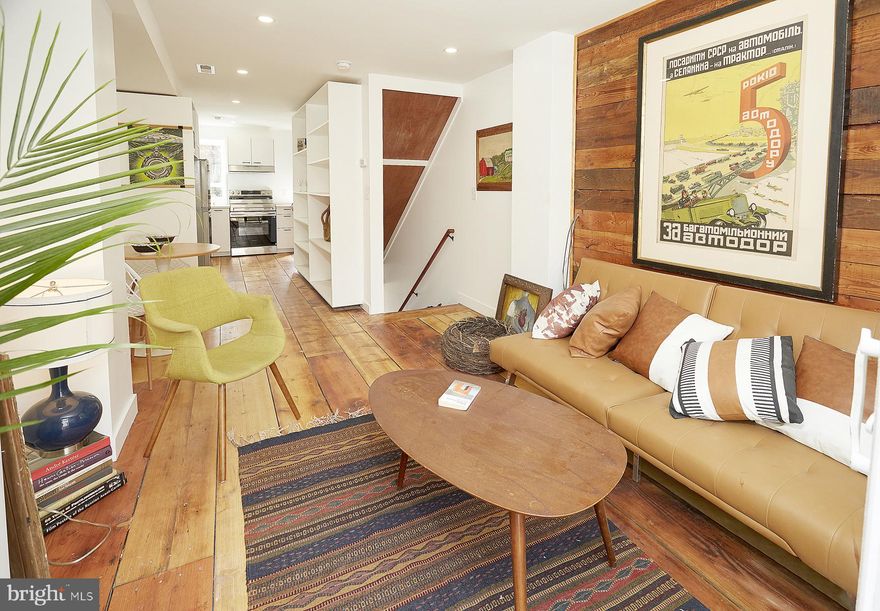 Experience three levels of thoughtfully finished living space in this newly renovated end-unit rowhome.  Step into the upper levels to find gorgeous wide-plank wood flooring and custom natural wood accents that infuse the home with warmth.  Be inspired by the kitchen's gleaming white quartz countertops, stainless steel appliances, and clever built-in storage for maximum functionality. Floor-to-ceiling glass sliding doors flood the interior with natural light, leading you to a private, fenced-in walk-out deck and brick patio that's perfect for outdoor living. 
Upper floor features 2 bedrooms and contemporary bathroom.  The lower level offers amazing flexibility with a private entrance from Lemmon Street and a 3rd bedroom with full bathroom.  Inquire about all the buyer incentives available including UMD's LNYW grants and Baltimore City's $10,000 Vacant 2 Value incentive.  HUGE 10 year tax savings as the sellers are in the process of obtaining approval for the 10 year CHAP tax credits.