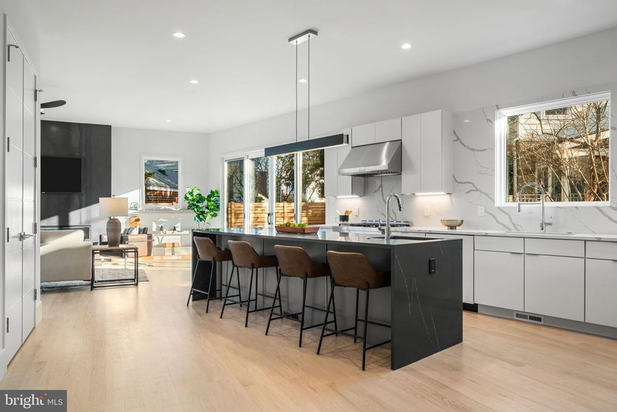 Built in 2025, The Third Street Modern is a striking new construction residence offering approximately 4,710 square feet across four finished levels with 6 bedrooms and 6 bathrooms, blending refined design with high-performance construction. The exterior showcases contemporary materials and a covered front porch with a wood-lined ceiling. Inside, the open main level features 10-foot ceilings, wide-plank red oak floors, and a dramatic four-story staircase framed by oversized Pella Lifestyle windows that flood the home with natural light. The family room is anchored by a 60-inch linear gas fireplace with hot-rolled steel detailing and flows seamlessly into the chef’s kitchen with a waterfall quartz island, prep sink, KitchenAid Energy Star appliances, dedicated pantry, and bright breakfast area. Floor-to-ceiling windows open to a covered rear deck and private backyard, creating an effortless indoor-outdoor connection.

The main level also includes a private office, a powder room with floating vanity, and a mudroom with built-in storage and access to the epoxy-floored garage with EV charging readiness. The lower level offers 9-foot ceilings, a spacious recreation room with wet bar and built-in cabinetry, a guest suite, fitness room, storage, and walk-up access to the backyard. The second level features a very private primary suite, thoughtfully positioned for separation and retreat, with a custom accent wall and integrated lighting, a spacious walk-in closet, and a spa-inspired bath with dual vanities, a freestanding soaking tub, and an oversized skylit shower. Also on this level are a generous laundry room with utility sink, a guest suite with ensuite bath, and two additional bedrooms connected by a Jack and Jill bathroom. The top level includes a vaulted loft-style family room and an additional bedroom with ensuite bath.

The fully finished walkout lower level offers 9-foot ceilings and exceptional flexibility, featuring a large recreation and living area with a built-in wet bar and cabinetry, a separate room ideal for a private fitness space or studio, a guest bedroom, and a full bathroom. Walk-up access to the backyard adds convenience and functionality, making this level well suited for guests, extended living, or entertaining.

Constructed with advanced systems including a standing seam metal roof, Advantech and Zip Wall construction, spray foam insulation, high-efficiency HVAC with electronic zoning, smart thermostats, LED lighting, permeable paving, and comprehensive stormwater management. Ideally located across from Lubber Run Park and Community Center, and moments to Ballston Metro, dining, shopping, and major commuter routes.