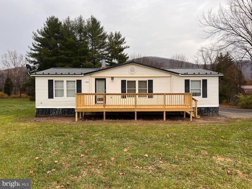 This mobile home has so much to offer! Everything is located on one level for your convenience. Inside you will find three bedrooms and two bathrooms with one being a primary bedroom attached to a bathroom with a large garden tub. Includes a spacious living room with a working fireplace (access to the front porch) and it even has a laundry room/mud room right off the back deck. Not only is this home located outside of city limits but the outside is set for enjoyment. Take your pick where to sit and relax, this home is equipped with a brand new front and back deck. The back deck comes with a hot tub and built in bar. If you don't like parking your vehicles outside, no worries! This home comes with a three bay heated garage, plenty room for vehicles and storage. Don't forget about the long paved driveway and two storage sheds that is also included. Seller is offering a year home warranty starting October. Seller is offering $2,500 credit for landscaping and painting to any reasonable offers. Come check out your new home!!!