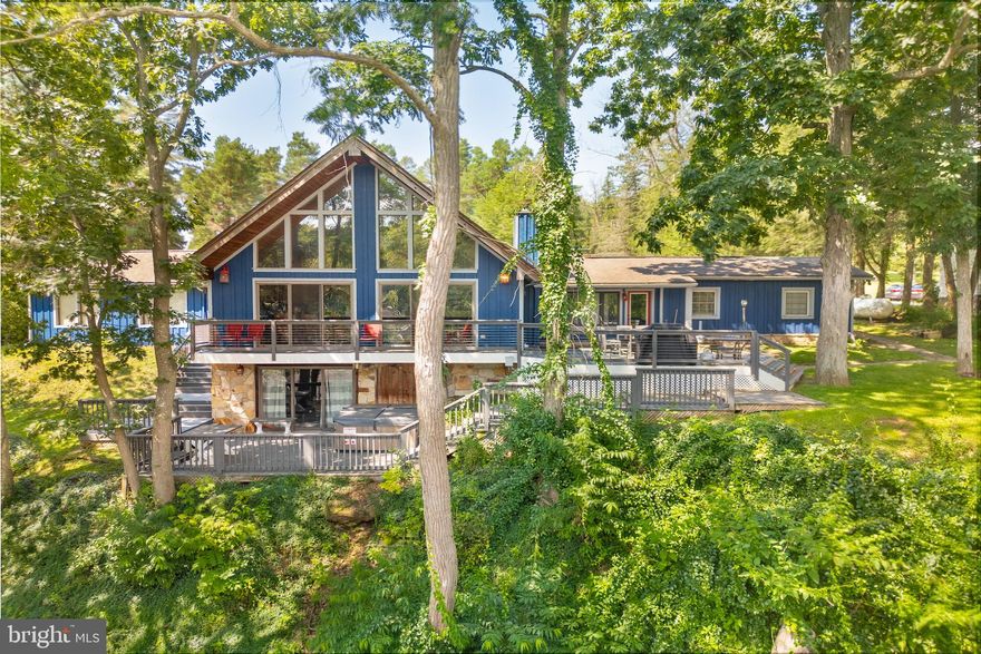 An investor’s dream and a lake lover’s retreat! Minutes from Wisp, this single family home features a dedicated dock slip and elevated, panoramic lake views from multiple rooms. It sleeps 12 with 4 bedrooms, 4 bathrooms, and a finished walkout basement complete with a full game room and bar — perfect for entertaining or relaxing after a day on the water or slopes. Just a few hundred feet from your assigned boat slip, this home averaged more than $50K annually in rental income from 2020 - 2025. A rustic stone fireplace, vaulted ceilings, hardwood floors, stainless appliances, and a modernized composite deck with wire railings offer both comfort and style. Recent updates include the HVAC system, polywood deck furniture, tankless water heater, washing machine, carpet and basement flooring. Rental guests love the three living areas, multiple outdoor spaces, relaxing hot tub, loft with a view, and convenient access to the lake and dock — and so do the owners. Whether it’s coffee on the deck at sunrise or unwinding by the firepit after a day of adventure, this home delivers unforgettable moments. With a two-car garage and locked owner’s closet for lake toys, ski gear, and tools, everything has its place. Whether you're looking to invest, escape, or both — this home is ready to enjoy.