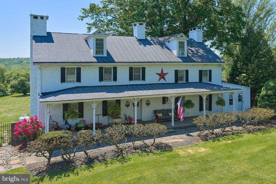 If you’re looking for a stone house in the Newtown area, this lovely 4 BR farmhouse will take your breath away. Sited on 5.61 acres, you’re surrounded by farmland while still within a short drive to town. Step out onto the rear flagstone patio and a whole vista opens up before you, while you take in the breeze under the shade of expansive oak trees. Built in 1830 and expanded over the years, this house exhibits many features unique to its successive eras, unfolding over time. The dining room, considered the original section of the house, hosts a huge walk-in fireplace that now contains a wood-burning stove. The living room features another large fireplace but slightly more modern, surrounded by a fine wood mantle. Windows are a little longer in size, interesting-shaped wall cabinets face each other across the room, and Dutch doors abound. Two more fireplaces grace the upstairs bedrooms. A new chef’s kitchen retains its farmhouse ambiance while offering an amazing amount of space and a six-burner Bertazzoni range with double-ovens. The office is paneled with maple, upstairs bathrooms have been updated, and an attic bonus room could serve as a fifth bedroom if needed. Enjoy an authentic period home in a zip code rarely graced with both a stone house and acreage. Council Rock school district!