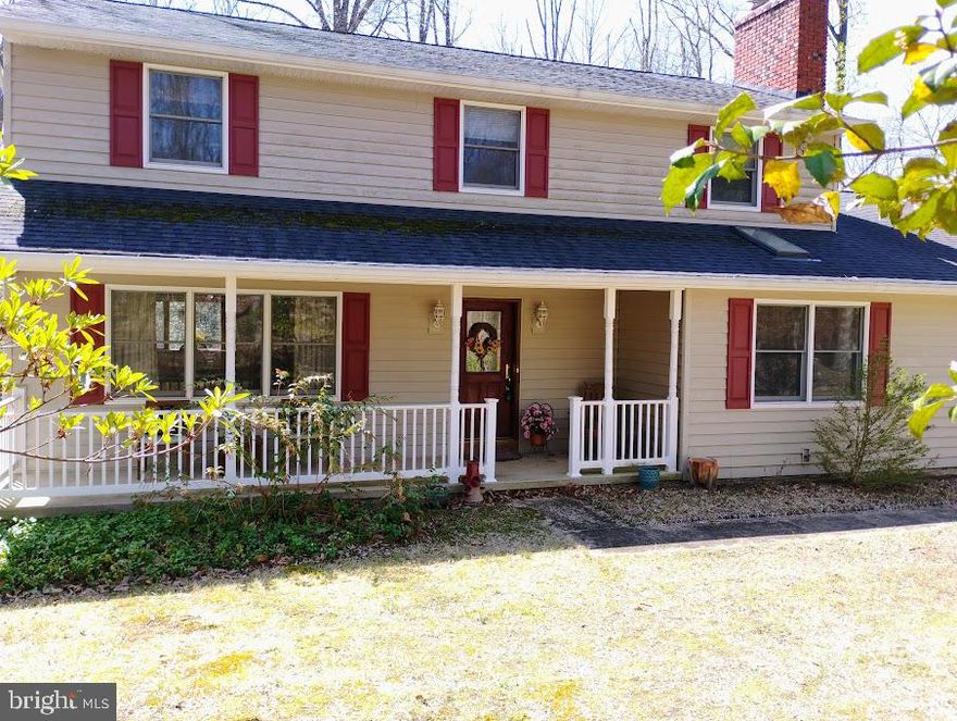 Unbelievable location! Your own private residence tucked away on just over 3 acres of tranquility. Home provides seclusion and convenience with nearby dining, parks and many waterways to enjoy just a short drive. The front porch is spacious enough to enjoy your serene space. As you enter into the foyer you may enjoy the family room that features a brick fireplace along with cherry stained wood floors and surrounded by natural light from the skylight or enter to the left into the formal living area with track lighting, cherry floors leading into the formal dining room with bay window overlooking the backyard and all the joys of nature. The spacious kitchen has wood cabinets along with quartz countertops  and stainless & black appliances. There is lots of room for family and friends to gather enjoying a meal inside or outside on the screen porch or lower tiered deck with hot tub as the gathering continues to move to the sprawling outdoors. Also the first floor offers a laundry room with sink and exterior door to walk outside between chores. **Added Bonus is the in-law suite with full bath, double closets and its own private entrance. Heading upstairs the home features 3 nice size bedrooms with double closets and a hall bathroom with double vanity to share. **Check out the 4th and primary bedroom we have a newly updated bathroom with granite and walk in shower and for those cozy nights you have your own fireplace. Now downstairs we are ready for your own personal touches in the basement featuring a walk out slider and a empty slate to create your dream room but in the mean time there is a slate pool table or table tennis waiting for playing pleasure. Rough in for Bathroom in Basement....Under deck storage....Roof, Siding, gutters, soffitts and deck replaced in 2014..HVAC replaced in 2020 with remaining warranty... This home is ready to be yours to make memories! The community offers access to a private community beach. When you love where you live a must needed easy commute to Baltimore, DC, Annapolis and Fort Meade or need a flight to BWI....WELCOME HOME....Voluntary Community Association-$125 year granting access and key to community beach located on Eagle Hill, chain across entrance at 349,,SELLER IS OFFERING A $5,000 CREDIT FOR CARPET REPLACEMENT