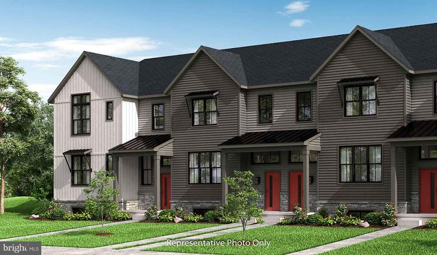 This 2-story, end-of-row townhome includes a first-floor owner’s suite, 2-car, rear load garage and a mudroom entry with built-in lockers and bench. Beautiful vinyl plank flooring adorns the main living areas on the first floor. The living room, accented by a fireplace, opens to the kitchen and dining area with sliding glass door access to a patio. The kitchen is well-appointed with stainless steel appliances, quartz countertops with a tile backsplash, and large center island. The owner’s suite, tucked quietly to the back of the home, features an expansive closet and a private bathroom with a tile shower and double bowl vanity. A laundry room is conveniently located across the hall from the suite. On the 2nd floor is a loft, two additional bedrooms, and a full bathroom.