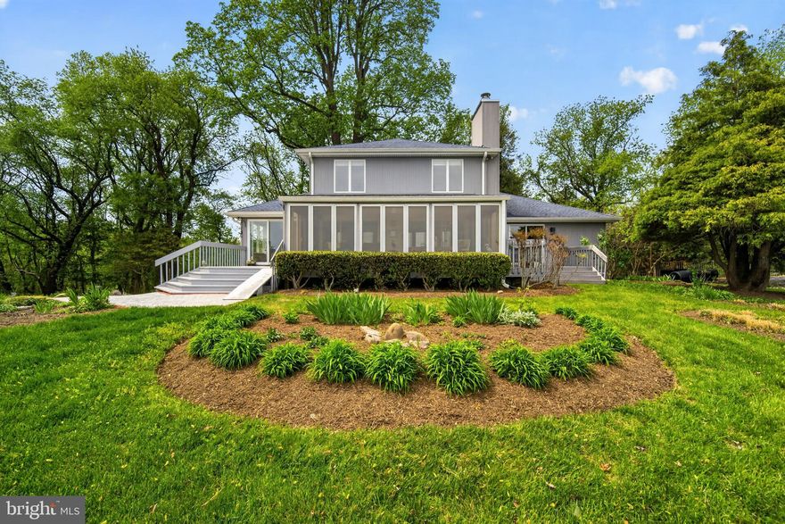 Welcome to 6920 Konrad Ct! Perched atop a hill on 1.2 acres at the end of a quiet cul-de-sac, this custom home, available for the first time, offers breathtaking, panoramic views of the Chesapeake Bay. Wake each morning to stunning sunrises over the water from the bright and spacious main-level primary suite, complete with an ensuite bath, seating area, two walk in closets and direct access to the deck—an ideal spot to take in the serene park-like setting.

The main level is designed for comfortable living and effortless entertaining, featuring a generous living and dining area with a gas fireplace, a well-appointed kitchen with double microwave/oven, stovetop, counter seating, and a casual eat-in space, plus a convenient half bath and rear screened in porch. The true centerpiece is the expansive four-season sunroom, where walls of windows frame sweeping bay views and lush green surroundings, creating a year-round retreat filled with natural light. Watch the eagles and ospreys soar over head and take in the herons in the pond. Hummingbirds, cardinals, mockingbirds and owls are just a few of the birds that call these grounds and birdfeeders home. 

Upstairs, an open two-story foyer leads to three additional bedrooms—two offering stunning water views and one overlooking the wooded backdrop—along with a full bath. The lower level provides approximately 1,800 square feet of additional space, including a large two-car garage and an unfinished basement currently used as an artist studio, workshop, and storage area—ready to be transformed to suit your vision.

Recent improvements include a newer roof with 6-inch gutters, gas fireplace, vinyl plank flooring, and a four-zone geothermal system.

Located just minutes from Herrington Harbour South Marina and the charming town of North Beach, with easy access to Annapolis, Old Town Alexandria, and Washington, DC, this home offers both tranquility and convenience. Enjoy community beach and bay access as well.

Bring your design ideas and personal touches to update and make this exceptional property truly your own. With its unmatched views and peaceful setting, this is a rare opportunity to create your dream home by the bay.