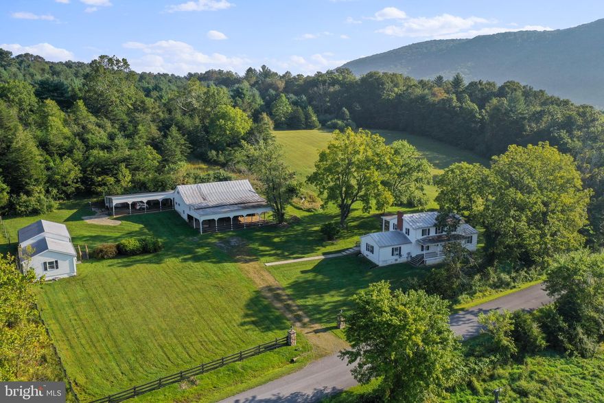 Welcome to "Whispering Winds" Farm!  This 2100 sq ft farmhouse is situated on 40+ acres touching the National Forest. The hardwood floors, exposed beams, and built-in shelves show off the character of this stately 1900's home.  The living room features a nice wood burning fireplace. Family room has vaulted wood ceilings.  3 br, 1.5 baths.   Gorgeous views and creek frontage.  Huge barn and several storage buildings offer plenty of room for your farming equipment or livestock. Timeless front porch and large patio in the back are perfect places to take in the views.  Don't wait to make this peaceful farm yours!  Call now to schedule a tour!