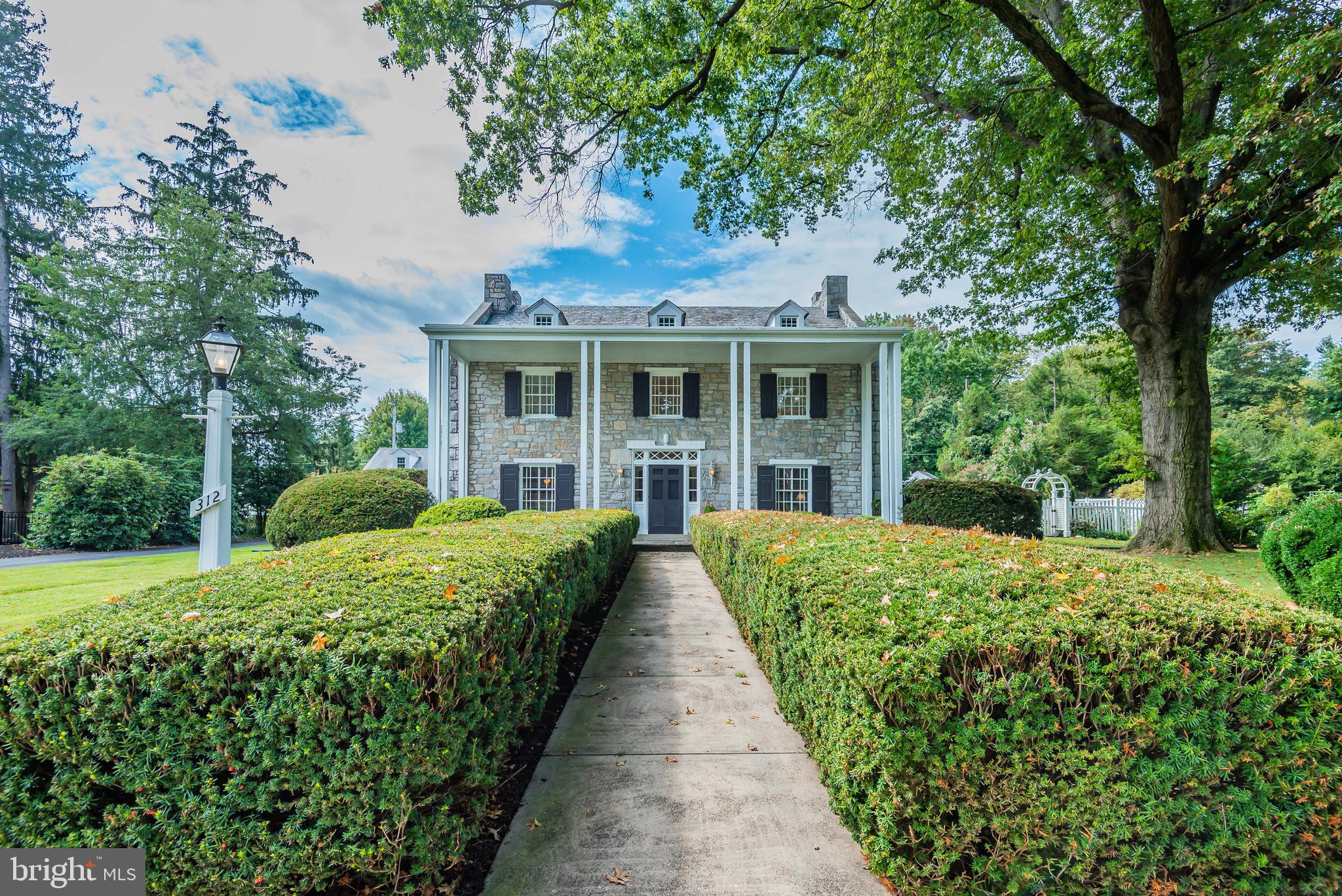 Stately Southern Colonial style home in Camp Hill Borough, Camp Hill Schools!  Built by the late Senator George N. Wade in 1939, this remarkable stone constructed home with slate roof, copper gutters and down spouts boasts 6 bedrooms, 5 full baths and 2 half baths.  With 6,000+ SF you will find the most beautiful charm throughout this home from the rich hardwood floors, original solid core paneled doors, high ceilings, crown moldings, exposed beams, and meticulous woodwork, coupled with 7 zones of hot water and radiant floor heat along with 4 zones of air conditioning - all powered by two 200 Amp electrical services, and all utility connections to the house are underground.  New first floor master suite addition features a tray ceiling, walk in closet, master bath with soaking tub, tile shower with body sprays and double vanity.  Attached to the master suite is an English conservatory which welcomes the outside in while overlooking the professionally groomed back yard, pool and jacuzzi.  There is also a half bath and kitchenette with ice maker off the conservatory/master suite.  Large formal dining room connects to the butler s pantry and wet bar which leads to the kitchen.  Kitchen features tons of cabinet space,  oven and microwave, 6 burner gas cook top, double door oversized refrigerator (all stainless steel) and tile backsplash.  Living room with fireplace, family room with fireplace and den/office with fireplace plus an additional half bath all still on the first floor.  Take one of three staircases to the second floor and find 5 bedrooms and 3 full baths.  There is a second floor master suite with built-ins, 3 closets, and an additional master bath with 2 full sized vanities.  Remaining 4 bedrooms upstairs all have a combination of plenty of closet space or walk in closets and access to a full bath either in the bedroom or just across the hall.  Send your laundry down the shoot and make your way to the  finished, walk-up basement (8  ceilings) with full second kitchen, full bath and large additional family/recreation room with fireplace.  The back yard oasis features an 18  x 40 , salt water chlorine gunite pool with gas heater and electric pool cover, separate winter cover, lighting system, and the best part is the jacuzzi is plumbed separately from the pool so you can use the hot tub year round even after you have closed the pool for the winter.  Pool can be totally controlled electronically by the inside wall controller, pool remote, or computer or your smart phone (no need to be at the pool equipment).  Pool house provides tons of storage space for all of your pool equipment and also includes a half bath for your pool guests and an outdoor beach-type hot water shower.  Plenty of storage space with two walk up attic spaces, one can be accessed from a hidden staircase on the second floor and another from the garage which spans above the entire oversized 3 car garage.  This home is one of a kind (only 2 owners since it was built in 1939), you won t find all of this history preserved in a home but still modernized with today s technology and amenities anywhere else!  Schedule your private tour today!