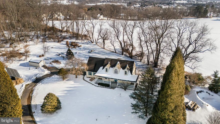 Charming Cape Cod – your private retreat at home.  Set back from the road on an elevated and secluded 1.45-acre lot, this bright and spacious Cape offers privacy, functionality, and flexible living. This lovely home welcomes you with a charming wrap-around covered front porch, the perfect place to enjoy peaceful views and summer breezes.
Step inside to an open and airy main level featuring hardwood flooring throughout the main living areas. The eat in kitchen offers ample counter space, recessed lighting,  and a sunny breakfast nook with lovely countryside views. From the kitchen, the layout flows effortlessly into the dining area and expansive great room, highlighted by vaulted ceilings, skylights, and a gas fireplace, creating a warm and inviting space for everyday living or entertaining. Sliding doors provide easy access to the rear yard and outdoor spaces.
The first-floor primary bedroom suite offers one-floor living, complete with a spacious bathroom featuring a walk-in shower. A convenient first-floor laundry adds to the home’s practicality and accessibility.
Upstairs, the open hallway overlooks the great room below and leads to two additional bedrooms and a full hall bath, offering comfortable accommodations for family or guests.
The finished lower level expands your living space even further, featuring a full bath, mini kitchenette, and ample storage—ideal for extended living, recreation, or hobby space.
Above the two-car garage, a generously sized bonus room includes vaulted ceilings, a gas fireplace, and its own brand new split heating and cooling system. This versatile space can easily serve as a fourth bedroom, home office, playroom, or additional family room. The 2 car garage also features an additional room for storage.
Outside, enjoy a screened rear porch, fire pit, fenced rear yard along with a small fenced poultry house and garden beds for those interested in hobby farming or homesteading. Utility costs are reduced by a 39-panel solar array, offering long-term energy savings.
Ideally located near Jennersville Medical Services and just a short drive along Baltimore Pike to shopping and dining in Jennersville and Oxford, this home combines privacy, efficiency, and flexible living spaces—all set upon a scenic hilltop setting. Move-in ready - freshly painted and all appliances included!