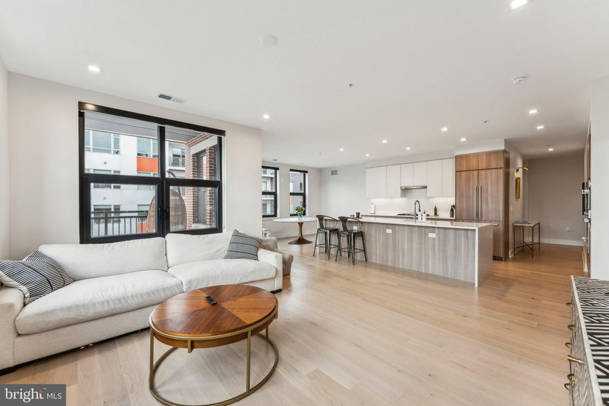 Welcome to 701 Swann Ave, Unit 402 — a rare three-bedroom opportunity and the largest residence in the building. Homes like this don’t come around often.

This expansive 3-bedroom, 2.5-bath condo delivers the space buyers want with the design they expect. 10-foot ceilings and floor-to-ceiling glass flood the home with natural light, creating an open, airy feel that immediately stands out. Every inch of this residence was thoughtfully designed for both everyday comfort and entertaining at scale.

The heart of the home is the open-concept living and dining area, anchored by a show-stopping chef’s kitchen. Quartz countertops with full-height backsplash, sleek Italian soft-close cabinetry, and premium Fisher & Paykel and Bosch appliances strike the perfect balance between style and function. A large center island with a built-in wine fridge offers extra storage and seating—perfect for hosting or casual nights in. Step onto your private, COVERED balcony to extend your living space outdoors.

The primary suite is a true retreat, featuring a spa-inspired bath with Waterworks fixtures, natural light, LED backlit mirrors, a built-in linen closet, and elegant Italian cabinetry. Two custom walk-in closets, equipped with custom closetry, complete the suite—because storage actually matters.

Two additional bedrooms provide flexibility for guests, a home office, or growing needs without compromise.

The building itself raises the bar, offering rooftop dining and lounge spaces with panoramic views, a fully equipped fitness center, arts and creative studio, pet wash station, full-time concierge, on-site resident manager, and building engineer. Translation: convenience, security, and lifestyle—all handled.

Location? Nailed it. Just moments from Potomac Yard Metro, Potomac Yard Park, Del Ray, and Founding Farmers, right across the street. You’re plugged in without sacrificing quality of life.

Two assigned garage parking spaces convey (G2-212 & G2-213)—a major win and not a given in this area. 

Residents of The Dylan enjoy a comprehensive collection of amenities designed to elevate daily living, including a rooftop outdoor dining terrace with sweeping panoramic views, a rooftop party room, a fully equipped fitness center, an arts and creative studio, a pet washing station, full-time concierge services, an on-site resident manager, and an on-site building engineer. Perfectly positioned moments from Potomac Yard Metro, Potomac Yard Park, Del Ray, and the newly opened Founding Farmers just across the street, this remarkable residence offers a rare blend of luxury, convenience, and iconic views in one of Northern Virginia's most dynamic neighborhoods . The condo fee covers all amenities, gas, water, and a master insurance policy. 

Bottom line:
This is a rare, oversized three-bedroom condo in a prime location with high-end finishes, full amenities, and parking. If space, light, and lifestyle are on your checklist. This one checks every box.