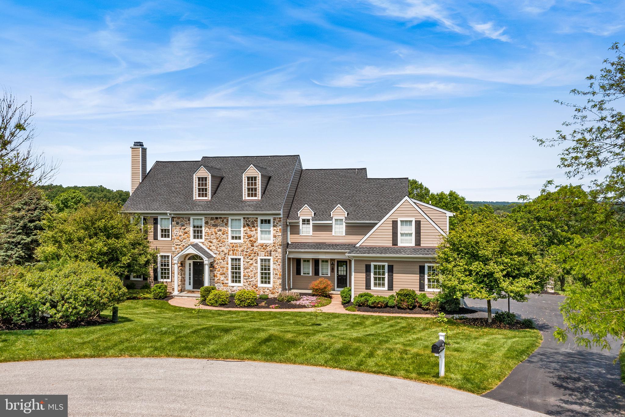 Welcome to this meticulously loved and cared for spectacular home with over 6000 sq ft of living space, including 5 BD and 5 ½ BA. Located in the highly sought after Unionville Chaddsford school district in the Olmsted community.
Entering through the front door into the two story grand foyer, you immediately feel the elegance that surrounds you. Gleaming hardwood floors greet you and stretch throughout the entire main floor. A traditional style main floor offers a formal living and dining room that flanks the foyer, with custom design wainscotting and crown molding. The entire floor connects creating the perfect atmosphere to entertain, or find yourself a quiet spot by the living room fireplace.
The rear of the house is a showstopper, with a brand new gourmet chef's kitchen, open to the great room with vaulted ceilings and fireplace, all overlooking the backyard and the view beyond.
The kitchen was just recently renovated highlighted by a 10 ft island with storage, quartz counters, all new appliances, double oven, and walk-in pantry just to name a few.
A gorgeous home office featuring built-ins and wainscotting, ½ bath, mudroom and laundry complete this floor.
Upstairs all 5 of the bedrooms are spacious, with great closet space and all drenched in natural light, while two share a full bathroom, two are suites with their own full baths.
The stunning primary bedroom is an oasis all on its own featuring a beautiful ensuite with tub and separate glass shower stall, dual closets, plus a linen closet and large bonus room.
An expansive walk-out basement is so roomy that it seems to go on forever. Additional living spaces include a family room area with cozy gas fireplace, full built-in bar with sliders that walk out to a hardscaped patio, separate home gym area with french doors for privacy and full bathroom. Could easily be converted as an in-law/au pair suite. Unfinished section for mechanicals also acts as sprawling area for storage.
Sitting on over an acre, additional features of the home and property include updated hardie board siding, a 3 car garage, mature trees, shrubs and greenery, a rear stone patio, a full walk up attic and breathtaking view