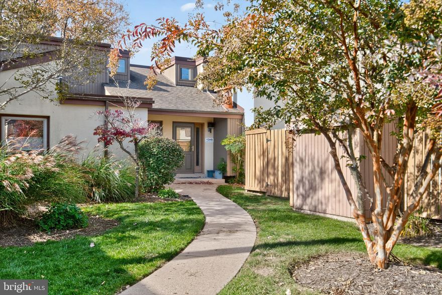 Welcome to this incredible 2-bed, 1.5-bath contemporary townhouse with upgrades galore in the sought-after Sierra Villas condo community. Enter the bright and airy two-story living room, centered around a charming wood-burning fireplace, perfect for entertaining or movie nights in. An adjoining dining area, with updated light fixture and sliding doors to the rear patio, creates an open layout for entertaining both indoors and out. Freshly painted and boasting upgraded flooring throughout (2025), the stunning finishes continue into the beautiful kitchen, showcasing white cabinetry with matte black accent hardware, quartz countertops, and upgraded stainless steel appliances (2021-2025). Just off the kitchen, a renovated powder room (2021) and laundry closet with washer and dryer provide everyday convenience, while another set of sliding doors leads directly to the peaceful patio, seamlessly extending the living space outdoors. Upstairs, you’ll find two generously sized bedrooms, each with new carpet (2025), ample closet space and bucolic tree-lined views. An updated full bath (2025) with a tub/shower combo serves both bedrooms. Step outside to a fully fenced patio with low-maintenance composite wood deck and gate access to community green space - the ideal space to create your own outdoor oasis. Additional updates include a new front door/transom and washer/dryer in 2020. Parking is simple via the dedicated carport space (#60) plus ample guest parking nearby. You will love the perks of Columbia living, including access to many Columbia Association amenities including pools, fitness facilities, golf courses, parks, ice rink, sports courts, skate arena, playgrounds and more. Ideally located, this home is just minutes from Howard Community College, Cedar Lane Park, Centennial Park, Whole Foods, and the vibrant Columbia Town Center with lakefront paths and countless shopping and dining options. Don't miss this!