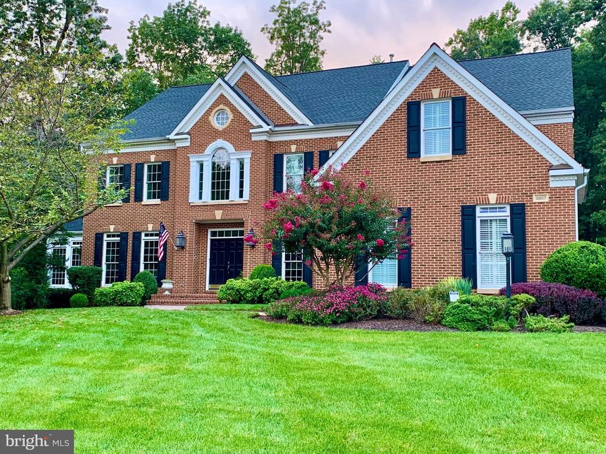 EXQUISITE CRAFTSMANSHIP, IMPECCABLE ATTENTION TO DETAIL - A MUST SEE! OPEN SUNDAY 7/16 2-5PM.  Discover a high standard of luxury in this fully Customized Randall model in Oak Hill Reserve.  This stunning 4-bedroom, 4.5-bathroom home boasts over 6000 square feet of living space, catering to the discerning buyer seeking both convenience and tranquility, making it an ideal sanctuary for working professionals. Situated on a generous .83-acre lot, the property is surrounded by a lush, manicured landscape, offering privacy and captivating views year round.

Architectural features define this home and contribute to its distinctive character.  -  grand double doors, an elegant 2-story foyer, floor-to-ceiling windows, transoms, rich hardwood flooring, elegant wood shutters, tray ceilings as well as oversized crown molding.  Every corner of this home exudes sophistication and charm.  It was designed with entertaining in mind, and is an entertainer's paradise. Imagine soothing melodies floating through the formal living and dining areas, complemented by an attached bar area for seamless hosting. Enjoy the convenience of surround sound throughout the main level and lower level, allowing for a vibrant atmosphere when entertaining. 

The spacious kitchen boasts a center island graced with Desert Breeze quartz, a new JennAir cooktop with telescoping downdraft, a separate prep sink, and ample seating.  Stainless steel appliances, including a double oven and a smart technology refrigerator complete the gourmet package, while a separate pantry ensures optimal storage. The adjoining breakfast room is sure to be a favorite location with floor-to-ceiling windows and wood shutters, offering both privacy and picturesque views of the tiered patio and expansive yard. Access to the outdoor entertainment areas is provided through the breakfast area or the two-level family room, as well as a walk-up from the lower level.

The family room is both cozy and inviting, featuring a floor-to-ceiling flagstone fireplace, a second staircase, and an overlook balcony. Additionally, the main level features an office with built-in cabinetry, a sun-filled conservatory, and all rooms are designed to maximize natural light through walls of windows.

The upper level primary bedroom suite promises with no details are overlooked - black walnut hardwood floors, exquisite crown molding, and a tray ceiling. A sitting area offers a tranquil space overlooking the rear yard, while dual walk-in closets with California Closet Systems. The en-suite bathroom offers a spa-like retreat, featuring heated floors, custom cabinets, an oversized vanity with dual sinks, an additional furniture-grade cabinet with glass doors, a separate soaking tub, and a large, luxurious shower adorned with high end fixtures and a rain head. Three additional bedrooms complete this level, one boasting an ensuite bath, perfect for accommodating guests. The other two offer generous walk-in closets and share a spa-like bath with an oversized walk-in shower, quartz countertops, and upgraded tile.

Fine craftsmanship and abundant space for entertainment continues on the lower level.  A custom-built bar provides ample seating for enjoying a game of billiards or watching a movie on the large projection screen. The full-use bar is equipped with sink, second dishwasher, a beverage fridge, and ample storage. For those seeking a retreat, there is an additional bonus room, and for extended stays, a den or potential in-law suite with a full bath and shower, Fitness enthusiasts will appreciate the spacious in-home gym.  The home's wall-mounted TVs, a projector, and a projection screen, along with pool table and 6 lower level barstools all convey.

This hidden gem offers convenience with its proximity to shopping, restaurants, Dulles International Airport, the Tech Corridor, major commuter routes and 2 metros.  Miles of walking and biking trails are easily accessible, adding to the appeal of this remarkable residence.