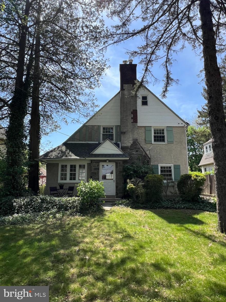 Welcome to this charming 1930s Colonial-style home with a touch of French Colonial flair, nestled just one block from the heart of Gladwyne. Located in the award-winning Lower Merion School District, this 4-bedroom, 1.5-bath home offers 1,883 square feet of timeless character and loads of potential on a spacious 0.21-acre lot.

Step inside to find hardwood floors throughout, with inlay detailing on the first floor that adds warmth and sophistication. The large living room features a wood-burning fireplace and built-in bookshelves. The main floor also includes a dedicated office space—ideal for remote work, and a half bath. Natural light pours into every room, enhanced by updated windows and charming outdoor window boxes ideal for seasonal flowers. 

A unique split staircase leads to both the kitchen and living areas, offering flexible flow and layout. One large window fills the stairway to the second floor with natural light. Three good sized bedrooms are located on the second floor along with the full bath including shower/tub combo and updated flooring. The third floor, complete with skylights, provides the 4th bedroom or additional living space, playroom, or office. 

Step outside to enjoy the large yard with mature plantings, a front patio perfect for morning coffee, and a slate patio in the back, complete with a frame for a canopy—ideal for outdoor dining and entertaining. The property also boasts a rare detached 3-car garage and a long driveway, providing ample parking and storage. 

Enjoy the walkable lifestyle with sidewalks and easy access to Gladwyne’s shops, dining, parks, and walking trails. Plus, you're conveniently located near all major transportation routes for an easy commute to Center City or beyond.

Classic architectural details abound, and while the home may benefit from some updating and 
refurbishing, it’s a perfect canvas to bring your vision to life. Don’t miss this opportunity to own a piece of Gladwyne charm—schedule your showing today!  *professional photos coming soon*