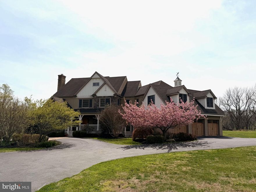 Set on 5.5 private acres within Indian Run Farm, this custom-built Weaver Construction residence is offered for the first time and presents a rare combination of timeless craftsmanship, generous living space, and a serene natural setting. Located in Malvern, the property offers convenient proximity to Main Line amenities, major commuting routes, regional rail, and the Tredyffrin/Easttown School District.  The home offers over 5,100 square feet of thoughtfully designed living space with 4 bedrooms, 5 full bathrooms, and 1 half bath.  A welcoming foyer is flanked by a light-filled home office with custom built-in cabinetry and a formal dining room, setting a refined yet inviting tone. The gourmet kitchen serves as the heart of the home and is equipped with stainless steel appliances, including a Thermador six-burner range with griddle, Miele double ovens and warming drawer, hot water-on-demand faucet, and a GE Monogram side-by-side refrigerator. Extensive cabinetry, a large center island, and space for a generously sized dining table create a warm gathering space well suited for hosting. The adjoining family room features a beamed ceiling, radiant heated floors, and a custom Franklin wood-burning fireplace. Large windows and French doors open to the rear porch, filling the space with natural light and offering views of the expansive backyard. A tiled rear entry from the three-car garage includes a walk-in closet, wine pantry, powder room, and mudroom with built-in storage for everyday organization. Upstairs, the primary suite provides a private retreat with views of the backyard, a walk-in closet with custom built-ins, and an en-suite bathroom featuring a double vanity, radiant heated floors, tiled walk-in shower, and private water closet. Three additional bedrooms, each with en-suite bathrooms and ample closet space, complete the second level, along with a second-floor laundry room.  The fourth bedroom features two adjoining rooms for added living flexibility. An open office area with built-in desks allows for work or relaxation options. The unfinished walk-up attic offers abundant storage or future expansion potential. The lower level includes a recreation room with space for games and seating, a full bathroom, multiple storage areas, and interior access to the garage, with additional unfinished space suitable for a home gym or storage. Outdoor living areas include pollinator-friendly gardens, a custom paver patio, fire pit, a rear porch, and a wraparound front porch, providing multiple inviting spaces to enjoy the surrounding landscape. Nearby access to trails and open space, including Valley Forge National Park and Cedar Hollow Preserve, further enhance the setting. Additional features include a Navien Energy Star tankless water heater, Sunny Boy solar panel system, EV charger, generator connection, underground electrical wiring, and an attached three-car garage with interior access and additional storage. The property offers a rare combination of peaceful, private setting and convenient access to Routes 202 and 30, the PA Turnpike, and regional rail, supporting easy travel throughout the Main Line and beyond. This residence presents an opportunity to enjoy refined living, space, and privacy while remaining closely connected to the lifestyle and conveniences associated with Main Line living.