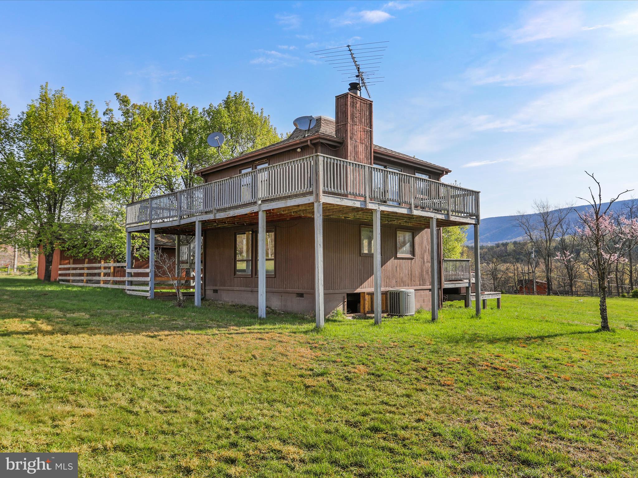 Enjoy your peaceful four-season home on 5 plus acres in the stunning mountains of West Virginia, just a short distance from the Cacapon River, in the desirable gated River Ridge Community, just 2 hours from DC and Baltimore. The home is one of the few homes that boast an unobstructed view of the magnificent Cacapon Mountain from the front deck. Within a short distance to the Cacapon River but not in a flood zone, the 5.61 acres of land has beautiful mature trees and landscaping. Two of the acres are a fenced meadow and the remaining 3+ acres are wooded.
This 3-bedroom, 1.5-bath home offers a rare blend of privacy, space, and potential. As one of the original first properties to be built in River Ridge, the home itself is in need of some TLC and updates, but it’s the perfect canvas for someone ready to bring their vision to life. Whether you're an investor, a weekend warrior, or someone looking to create a custom getaway, the possibilities here are endless. With heavenly views from the upper deck to the wood burning fireplace inside and access to the Cacapon, this home offers lots of possibilities! Enjoy evenings outside around the fire pit or relax in the recently serviced hot tub as you take in the views around you. The detached garage adds extra value and versatility — great for secure parking, storage, or transforming into a workshop, hobby space, or studio. Whether you're looking for a place to tinker, create, or just keep your tools and equipment protected, it’s a great bonus feature with tons of potential. Great opportunities to enjoy hiking, swimming, kayaking, fishing and the peaceful tranquility the home has to offer. Home is being sold as -is. Book your showing today!