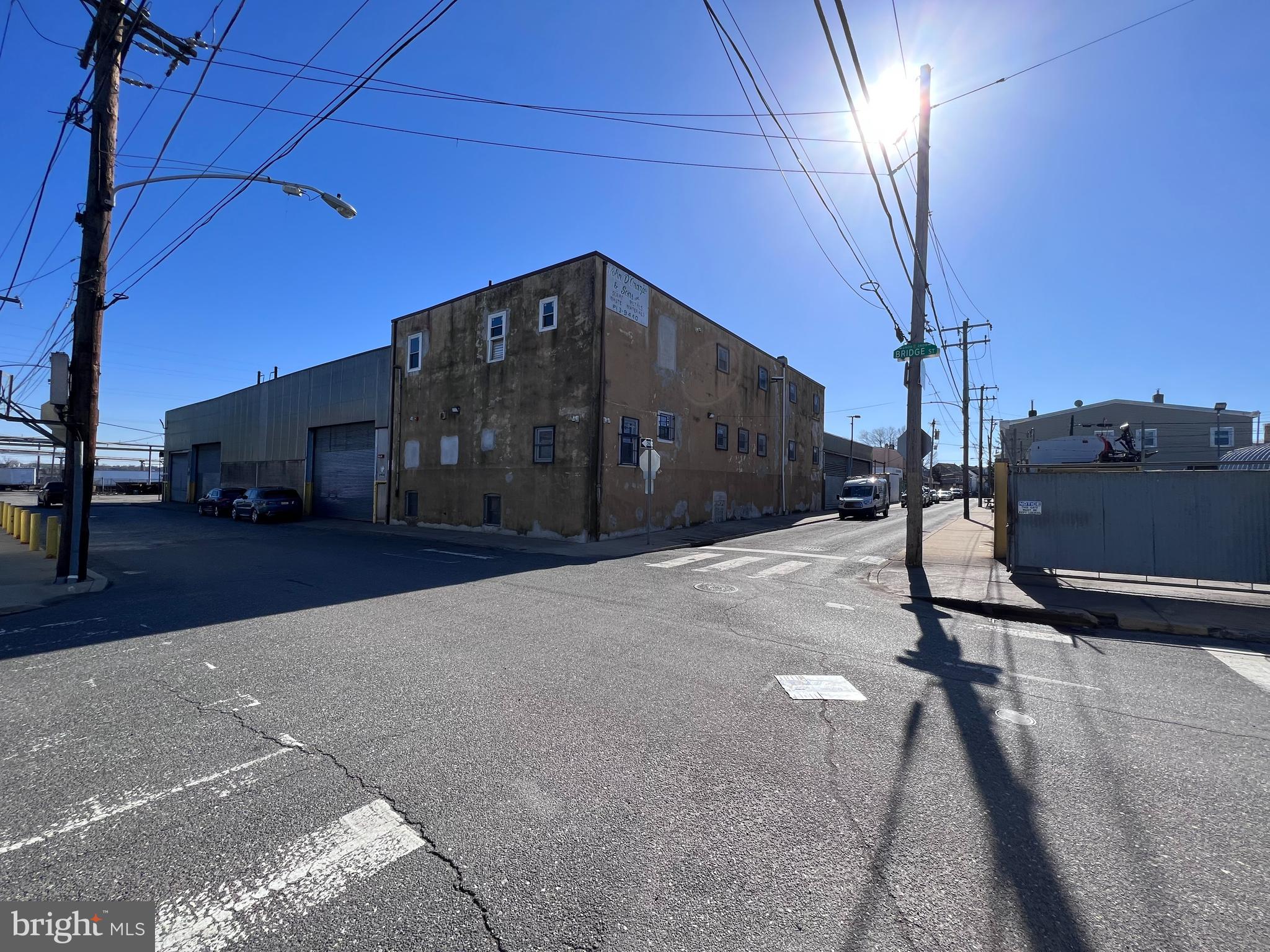 The property located at 2900-30 Bridge St in Philadelphia, PA, is a highly desirable warehouse with finished office space situated on a prime corner lot. This property boasts easy access to I95 and Delaware Avenue, making it an excellent location for businesses seeking accessibility and convenience.
The property spans approximately 30,000 +/- square feet, offering ample space for a range of industrial, manufacturing, or logistics purposes. The building features a 26' ceiling height, making it perfect for high-capacity storage or large machinery.
Additionally, the property features five tailboard loading docks that can easily accommodate full-size tractor trailers, making it highly functional for businesses that require frequent shipping and receiving. Furthermore, the building has three roll-up doors along Bridge St. Two of these doors are 16' H x 25' W, while the third door is 13' H x 25' W, providing flexible access to the warehouse floor.
The property is further enhanced by two additional roll-up doors that give access from Gardner St. into a garage space, providing convenient options for storage or workspace. The building also features a 13,200-volt electric connection, along with access to public water and sewer systems.
The property's flexible ICMX zoning for all three parcels (2900, 2920, 2930) allows for a range of uses, including manufacturing, distribution, warehousing, and retail. This property's location adjacent to the planned extension of the Bridesburg North Trail and the Delaware Ave extension makes it an attractive investment opportunity, with the potential for future development or expansion. Overall, this property is an exceptional opportunity for businesses seeking a prime location, flexible zoning, and ample space for their operations.