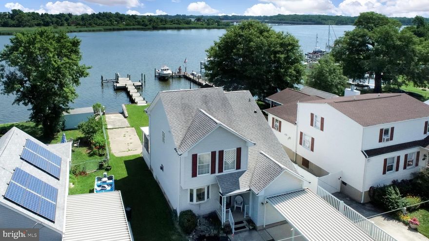 Back on the Market, fully Appraised at value ! Their loss is your gain!
Waterfront Oasis was built in 2001. Private Boat Ramp! The interior features 2 Stories, 3 Beds, and 2.5 Baths. Carpeted Flooring and Vinyl Tiles throughout. The Main Level features a carpeted Living Room with an Electric Fireplace.  The Kitchen has all the needed appliances. Plenty of counter space and cabinetry.  The Rear Glass Sliding Door by the Kitchen goes directly to the 3 Season Screened Porch.  A Half Bath on the Main Level. The Upper Level has the Primary Bedroom (fully carpeted) with En suite Bathroom. 2 Fully Carpeted Bedrooms and 1 Full Bath. The Exterior boasts a Trex Deck with 3 Benches and 2 Flower Boxes - perfect for sunbathing. A 44 ft. Dock with an Electric Boat Lift + Lights. 3' Low Mean Water.  Spacious Backyard overlooking the water. A Storage Shed near the private pier.