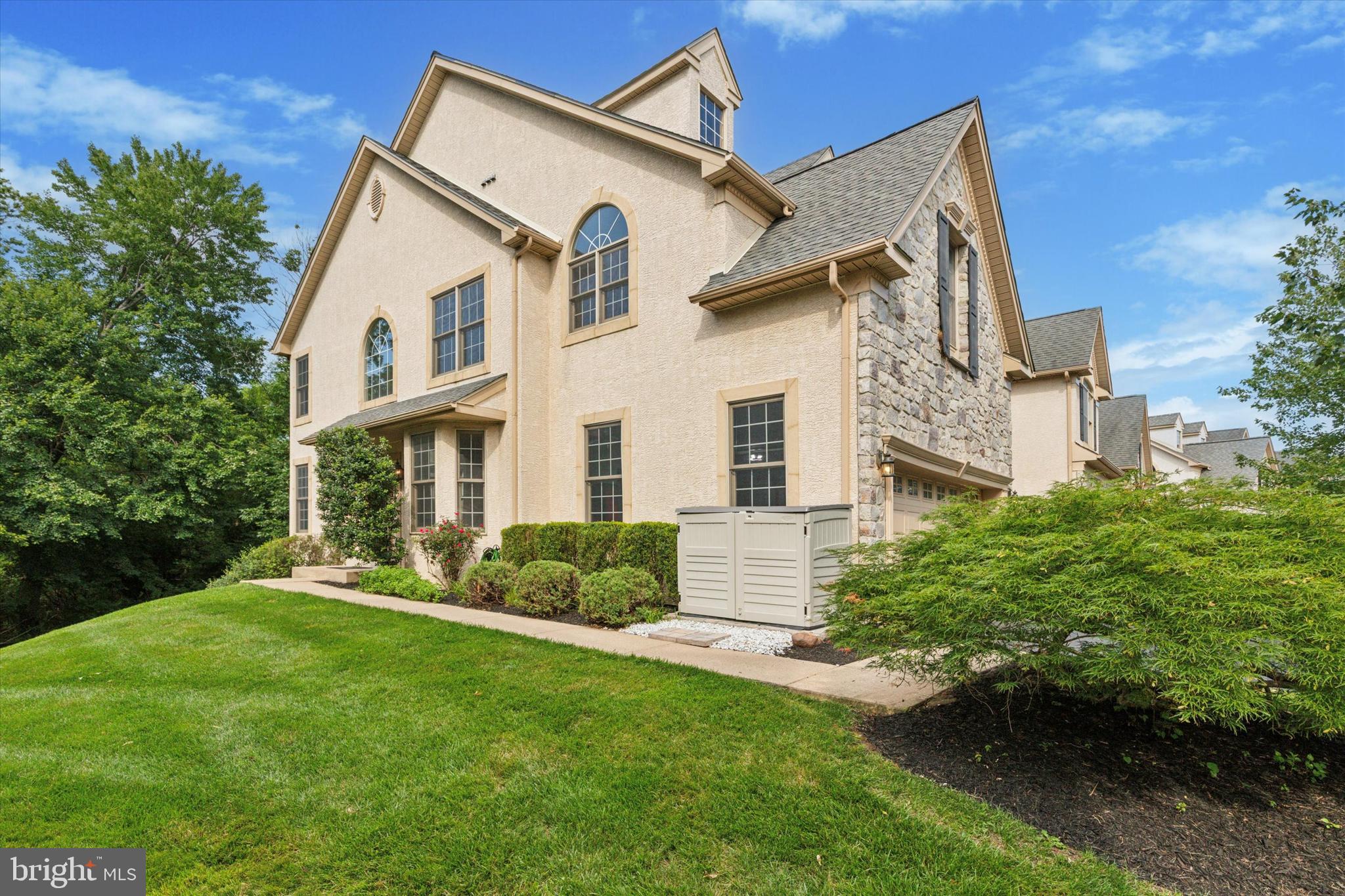 Zillow Users, check out the video of this home under Facts and Features, Interiors, Video and Virtual Tour. Check put the open house schedule on 7/11-13. Nestled on one of the premier lots in the highly sought-after Reserve at Penn Crossing, 29 Penn Crossing Dr is a beautifully maintained, end-unit luxury carriage home offering 3 bedrooms, 3 full bathrooms, and 1 half bath. This smart and modern home also features a state of the art home theater and a finished walk-out basement.
Step into the grand two-story foyer, where gleaming hardwood floors and a striking oak-turned staircase greet you beneath a large fixed arched window that brings in a lot of light. To the left, double French doors open to a private flex room—perfect for an office, library, formal living space, or guest room. To the right, a formal dining room with a bay window, custom trim, and elegant millwork sets the stage for entertaining.
The adjacent wet bar and butler’s pantry with a wine fridge lead seamlessly into the gourmet kitchen, featuring 42" cabinetry, granite countertops, a center island, gas cooktop, smart refrigerator and a cozy breakfast area filled with natural light. The kitchen flows into a dramatic two-story family room with vaulted ceilings, palladium windows, a gas fireplace, and two sets of French doors that open onto a private deck with tranquil wooded views. A powder room and access to a gorgeous the two-car garage complete the main level. The garage features an interlocking floor tile with drainage, a motorized overhead storage platform, a storage cabinet system and a Tesla electronic charger.
Downstairs, the finished lower level offers a fully equipped home theater with a projector and surround sound—perfect for movie nights or game days. This level also includes a full modern bath, laundry room, storage area, two big windows that bring in a lot of light and sliding doors that lead to a rear patio and wooded backyard.
Upstairs, a curved balcony overlooks the family room. The grand primary suite features a double-door entry, cathedral ceilings, two walk-in closets, and a versatile sitting room. The luxurious ensuite bath includes a jacuzzi tub, frameless glass shower, and double vanity. Two additional spacious bedrooms share a well-appointed hall bath with a tub/shower combo.
Reserve at Penn Crossing is a charming and scenic, tree lined neighborhood which offers 2 dog parks, a pond with an illuminated fountain and a walking trail to a nearby shopping center with stores like Starbucks, Chick-Fill-A and Staples. Parking and guest accommodations are ample, with a two-car garage, a driveway for four more cars, and nearby common parking. This smart home also features voice activated device connected to Alexa which can control the lights and ceiling fans. For convenience, there is also a in-ground lawn sprinkler. The low homeowner association fees covers lawn maintenance, spring clean-up with mulch and snow removal. Close to major roads like 276, 476, 76, 202 and around 35 minutes drive to Philadelphia Airport and Center City Philadelphia, 20 minutes to King of Prussia Mall and 10 mins to Plymouth Meeting Mall and Wholefoods.
Enjoy peaceful surroundings, thoughtful details, modern convenience, great location and the ease of maintenance-free living in one of the area’s most desirable communities.