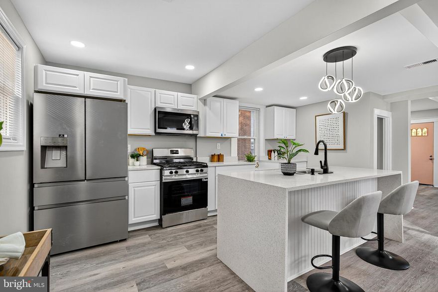 Welcome to 5108 Saint Georges Ave! This beautifully and completely renovated home offers the perfect blend of classic charm and sleek, designer finishes throughout. From the striking curb appeal to the fully finished lower level, this property delivers a modern lifestyle in a welcoming neighborhood setting.
Step inside to discover an open-concept living, dining, and kitchen area designed for entertaining. The living room immediately captures attention with a dramatic, navy blue coffered ceiling accented by white trim and a gorgeous crystal and gold chandelier. A cozy seating area is anchored by a black brick fireplace, perfect for chilly evenings. The heart of the home features a stunning, all-white kitchen with new stainless steel appliances, white shaker cabinetry, and a spacious quartz waterfall island. The island provides a fantastic gathering space with bar seating and a sleek black faucet and hardware package. The area flows seamlessly into a dedicated dining space illuminated by a contemporary geometric pendant light. An additional sunroom/flex room offers bright, versatile space, separated by classic French doors.
Throughout the main floor, you'll find elegant greige walls, white trim, and low-maintenance, modern grey luxury vinyl plank flooring. The entryway features a charming bench and coat rack for a perfect drop-zone.
Upstairs, the bright bedrooms feature plush new grey carpeting and are painted in the same soothing, neutral palette, offering a peaceful retreat. The home boasts newly renovated bathrooms with high-end style. Enjoy a bath surrounded by chic white marble-look tiling. One bathroom features a striking gold accent package including fixtures, a round mirror, and a hexagon-patterned niche, while another showcases clean white subway tile and modern black fixtures. The fully finished lower level dramatically expands the living space, offering incredible flexibility. The exterior presents a classic two-story home with a fresh grey paint scheme and charming front porch. The property features a large, fenced-in backyard with mature trees and a storage shed, providing plenty of space for gardening, recreation, and outdoor entertaining.
This meticulously updated home is truly move-in ready and waiting for its new owner. Schedule your showing today!