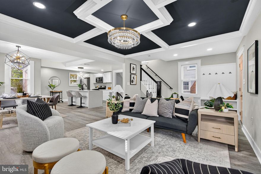 Welcome to 5108 Saint Georges Ave! This beautifully and completely renovated home offers the perfect blend of classic charm and sleek, designer finishes throughout. From the striking curb appeal to the fully finished lower level, this property delivers a modern lifestyle in a welcoming neighborhood setting.
Step inside to discover an open-concept living, dining, and kitchen area designed for entertaining. The living room immediately captures attention with a dramatic, navy blue coffered ceiling accented by white trim and a gorgeous crystal and gold chandelier. A cozy seating area is anchored by a black brick fireplace, perfect for chilly evenings. The heart of the home features a stunning, all-white kitchen with new stainless steel appliances, white shaker cabinetry, and a spacious quartz waterfall island. The island provides a fantastic gathering space with bar seating and a sleek black faucet and hardware package. The area flows seamlessly into a dedicated dining space illuminated by a contemporary geometric pendant light. An additional sunroom/flex room offers bright, versatile space, separated by classic French doors.
Throughout the main floor, you'll find elegant greige walls, white trim, and low-maintenance, modern grey luxury vinyl plank flooring. The entryway features a charming bench and coat rack for a perfect drop-zone.
Upstairs, the bright bedrooms feature plush new grey carpeting and are painted in the same soothing, neutral palette, offering a peaceful retreat. The home boasts newly renovated bathrooms with high-end style. Enjoy a bath surrounded by chic white marble-look tiling. One bathroom features a striking gold accent package including fixtures, a round mirror, and a hexagon-patterned niche, while another showcases clean white subway tile and modern black fixtures. The fully finished lower level dramatically expands the living space, offering incredible flexibility. The exterior presents a classic two-story home with a fresh grey paint scheme and charming front porch. The property features a large, fenced-in backyard with mature trees and a storage shed, providing plenty of space for gardening, recreation, and outdoor entertaining.
This meticulously updated home is truly move-in ready and waiting for its new owner. Schedule your showing today!