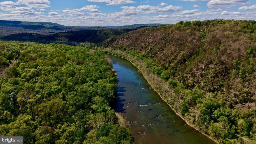 Potomac River Access: 0.5 Acre w/ Mountain Views & Historic Setting

Rare opportunity to own a 0.5-acre parcel with deeded easement access to the Potomac River, just an easy, flat 5-minute walk from the property. Mountain views in every direction in a private setting with a unique rail corridor backdrop, ideal for camping, a cabin retreat, or a one-of-a-kind getaway.

Approved for a conventional (Class I) septic system with completed design for a 3-bedroom home and power available at the property. Private well required for water service.

The property has been cleared, surveyed with marked corners, and includes a started driveway, saving time for the next owner. A recorded right-of-way provides convenient, usable access to the river for fishing, kayaking, and outdoor recreation.

Allowing flexibility for camping and recreational use. Private setting with minimal nearby development.

Just a short drive to Berkeley Springs, known for its historic charm, dining, shops, and natural springs. One of the few available parcels in the area combining easy river access with build-ready improvements already in place.