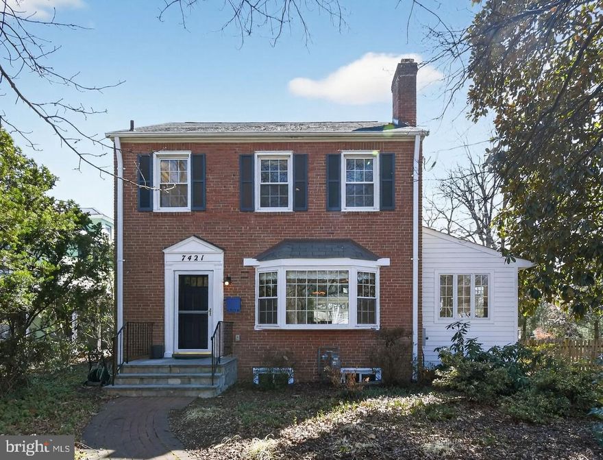 Nestled in the heart of the popular Historic North Takoma neighborhood, the stunning property at 7421 Buffalo Avenue offers the perfect blend of classic colonial charm with a breathtaking, modern two-story addition. Located just six blocks from the Takoma Metro and the vibrant downtown scene, this home is a sanctuary of functionality and modern architectural design. 
 A side hall entry featuring a coat closet, custom board and batten wainscoting, and a clever knee wall with built-in storage provides a functional transition into the home.
The classic living room is anchored by a wood-burning fireplace with a marble surround and a large bay window that floods the space with light . A dedicated flex space off the living room featuring vaulted ceilings, exposed brick walls, parquet floors, and wood trim windows on three sides is an ideal, quiet retreat for remote work.
The gourmet kitchen features stylish  pebblestone backsplash, ample cabinetry, and lighted open-shelf accents. A breakfast bar opens to the show-stopping family room. This room will steal your heart! The sophisticated design features floor-to-ceiling windows overlooking the yard, and is anchored by dark hardwood floors, a stone mosaic accent wall, and a large breakfast bar connecting to the kitchen. A powder room with high-end large-format copper tiles serves the main floor.  Off the family room is a spacious screened-in porch, perfect for three-season relaxation.
Upstairs is a primary suite sanctuary featuring vaulted ceilings with exposed wood beams and a Fir tongue-and-groove accent wall. Floor-to-ceiling windows offer serene views of the rear yard. The spa-like primary bath includes heated floors, a large shower stall with both wall and ceiling heads, stylish mosaic tile detailing, and a separate water closet.
Dressing Area & Laundry: The former third bedroom has been expertly converted into a convenient laundry room that leads to a dressing area with extensive built-in storage and clerestory windows.
Two additional bedrooms are upstairs with a renovated hall bath featuring heated penny-round tile floors and modern subway tile detailing.
The lower level versatile space includes a large flex room and a full bath equipped with an egress window, allowing it to serve as a fourth bedroom, guest suite, or additional family room.
The expansive, landscaped and fenced yard is a curated collection of year-round beauty, featuring native perennial shrubs, grasses, and trees including: Black Gum, White Pine, and Serviceberry trees, Winterberry, Black Chokecherry, St. John's Wort, Fothergilla, and Arrowwood Viburnum, and sedge grasses.  Truly a natural oasis. You are 6 Blocks to Takoma Metro (Red Line), with easy access to downtown Takoma Park shops and dining yet tucked away on a quiet, sought-after street.
Experience the very best of Takoma Park living at 7421 Buffalo Avenue!