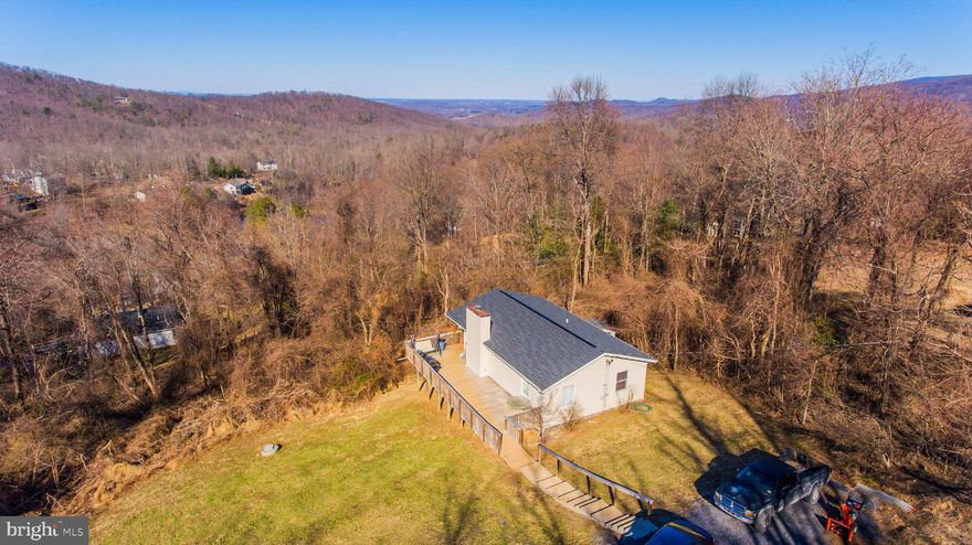 Welcome to what once was called Twin Lakes because of it's 2 small lake areas.  In the late 1970's the name was changed to Apple Mountain Lake, and quickly became a highly sought after commuter location. Awesome commuter location with easy access to I66 & I81. Relax & unwind lakeside this summer.  Bask on the beach & pic-nic area with friends & just chill. Head back to the house for the sunsets & enjoy the cool mountain breezes. Over sized deck offers tons of space for grilling, fire it & more fun times. Smaller is better these days. This isn't a tiny home but lends itself to less maintenance and yard work.  Open concept floor plan with gas fireplace to take the chill off next winter.  2 bedrooms on upper level and possible 3rd in lower level or a great home office / craft room or home gym in the lower level. There is also room for small efficiency  set up & family room with 1/2 bath. Ideal 2nd living quarters with separate entrance.  Upper level enclosed porch is great space for pets & storage!