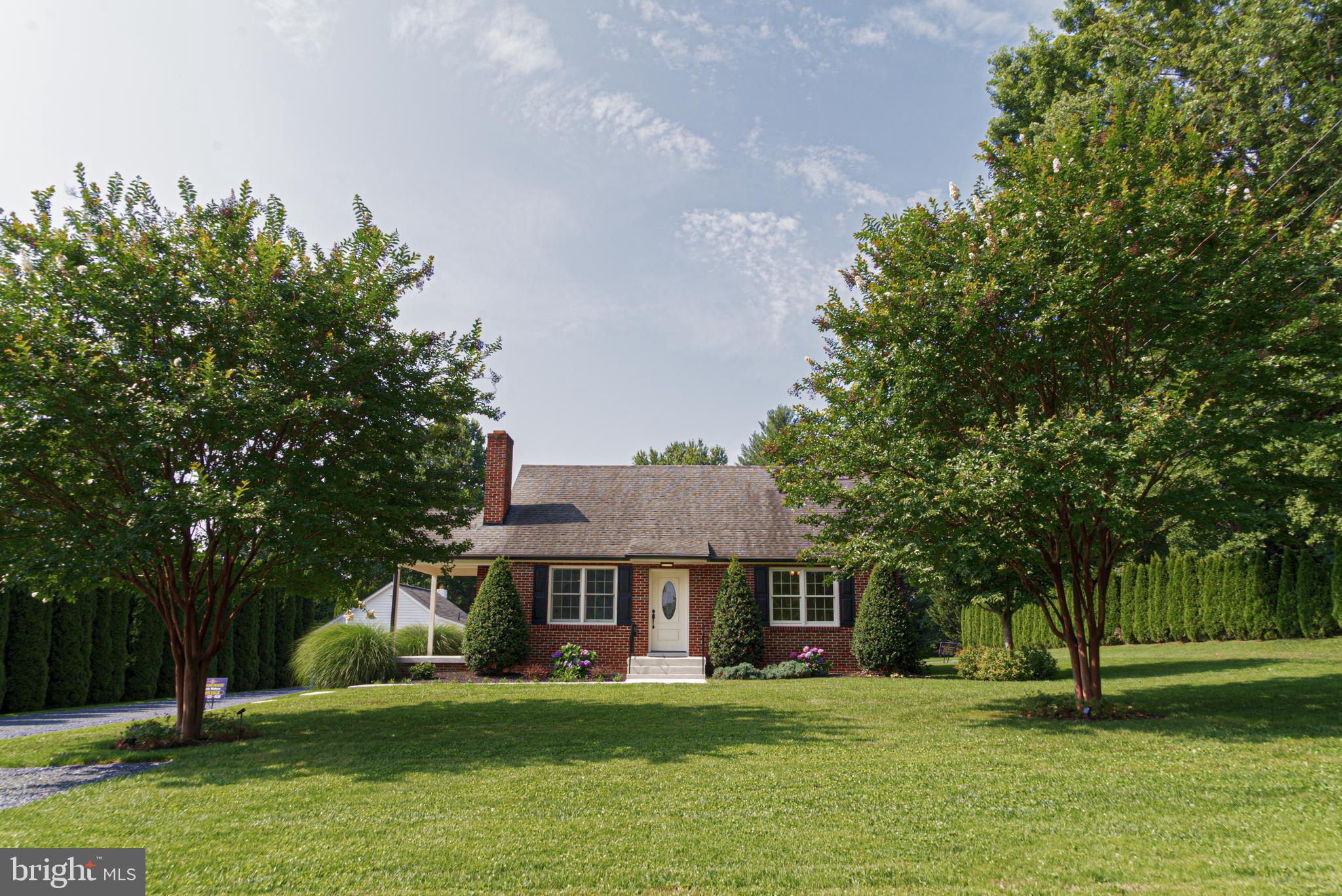 WELCOME HOME! - Beautiful BRICK COTTAGE with approx. 2,000 s.f of finished space on .6 acre lot in Western Howard County. This beautiful home has been completely remodeled inside and out, top to bottom in June 2023. 2 bedroom, 1 full bath on main floor, living room with wood burning fireplace, remodeled custom kitchen. 2nd floor offers another room that can be finished for a bedroom, office, craft room, whatever you desire. Lower level offers either a fully finished family room or convert to 3rd bedroom and a custom full bath. Separate rear entrance and finished utility room. New well tank. New Gutters. Heating - Dual Fuel (2 different supplies of heat). Heat Pump/Hydronic heat - concealed radiator. Central Air. This property has an ADDITIONAL finished building that can be used for office, gym, studio, and includes a mini refrigerator/microwave and half bath.
