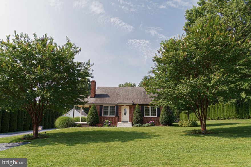 WELCOME HOME! - Beautiful BRICK COTTAGE with approx. 2,000 s.f of finished space on .6 acre lot in Western Howard County.  This beautiful home has been completely remodeled inside and out, top to bottom in June 2023.  2 bedroom, 1 full bath on main floor, living room with wood burning fireplace, remodeled custom kitchen.  2nd floor offers another room that can be finished for a bedroom, office, craft room, whatever you desire.  Lower level offers either a fully finished family room or convert to 3rd bedroom and a custom full bath. Separate rear entrance and finished utility room. New well tank. New Gutters. Heating - Dual Fuel (2 different supplies of heat). Heat Pump/Hydronic heat - concealed radiator. Central Air. This property has an ADDITIONAL finished building that can be used for office, gym, studio, and includes a mini refrigerator/microwave and half bath.