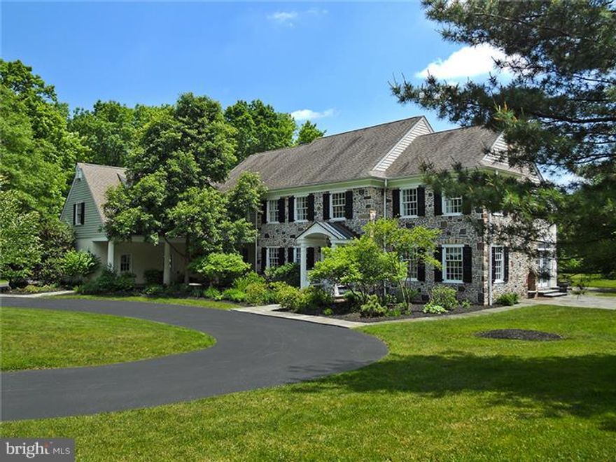 The experience of privacy and serenity in a picturesque setting of tall trees on 4 acres in the heart of Gwynedd Valley. Incredible views from every vantage point and overlooking the Wissahickon Creek and preserved lands, this classic stone, cedar and stucco home showcases superior  construction and architectural detail: porticoes, hinged shutters, half-round gutters, bluestone walkways and terraces. The interior is finished with lavish millwork, wide pine floors and custom tile on the main level, site-finished oak floors on the second, and six fireplaces. A bridged staircase leading to a second story window seat and French doors to the rear terrace highlight a dramatic center entrance foyer that opens to spacious rooms designed for entertaining. Touches of arts and crafts detail are most notable in the handsome paneled living room with wet bar, window seat, garden door to the terrace and a walk-in fireplace with an artisan tile surround. Adjacent to the dining room, the butler's service area includes a bar sink and custom cabinetry with an exceptional glass tile and fish back splash. The masterfully designed country kitchen offers plenty of space for everyday living and entertaining and was designed around a huge maple butcher block island with vegetable sink. It features top of the line appliances, hand crafted cherry cabinetry, granite counter tops  with a vegetable sink. The open design incorporates the breakfast area and great room, two more fireplaces and rear window walls for view watching. Gas fireplaces are included in the main bedroom suite with sitting area and luxurious bath as well as one of the three additional bedroom suites. In addition to a walk-up attic, the second level includes a 34'x 20'storage area that could easily be finished. The walk-out lower level includes a game room, daylight office area, workout room and climate controlled wine cellar. A separate 2 car storage building provides overflow for the attached 3 car garage. This unique offering is within walking distance to the train to center city Philadelphia with a stop at Germantown Academy . All of the amenities of suburban living...simply breathtaking!!!