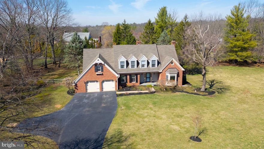 Nestled in one of Gwynedd Valley’s most sought-after neighborhoods, this charming 4-bedroom, 2.5-bath Cape Cod offers nearly 3,800 square feet of thoughtfully designed living space—far exceeding the size of a traditional Cape. While it boasts the classic central fireplace, its expansive layout and modern updates make it a standout. Set on a picturesque 1.4-acre lot, the property features both a spacious side yard and a fenced-in rear yard—perfect for outdoor enjoyment. Its coveted Lower Gwynedd location offers direct access to some of the area's best walking trails and a safe, walkable route for students attending Wissahickon Middle and High Schools—no waiting for the bus or relying on a ride from Mom and Dad! This convenience is a game-changer for busy families juggling after-school activities and sports. Step inside to a welcoming foyer with wide entryways and recessed stairs. To the right, a stylish home office with custom built-ins sits next to a sunken living room featuring a cozy wood-burning fireplace and pocket doors for added privacy. Across the foyer, the stunning formal dining room offers generous proportions, perfect for hosting holiday gatherings. The refreshed kitchen is both functional and inviting, featuring granite countertops, a center island, and ample space for a breakfast table. Love natural light? The adjacent sunroom is an ideal space for casual dining and offers access to a large rear deck, where you can enjoy al fresco meals while taking in the sights and sounds of nature. At the heart of the home (and my personal favorite room) is the spectacular family room, where soaring ceilings and a dramatic floor-to-ceiling brick fireplace create an inviting, warm ambiance.
Upstairs, the spacious owner’s suite is a private retreat, featuring a sitting area, a walk-in closet, and a well-appointed ensuite bath with a soaking tub, dual vanity, and stall shower. The additional bedrooms are generously sized, with beautiful hardwood floors, while front-facing dormer windows add extra charm. A hall bath with a tub-shower completes this level. The unfinished basement offers endless possibilities—whether you envision a home gym, playroom, or additional storage. A large cedar closet keeps off-season wardrobes pristine, and the exterior egress provides easy backyard access. Located in the highly ranked Wissahickon School District, this home is just moments from scenic walking trails, parks, fantastic local dining, shopping, and regional rail for an easy commute. Don’t miss this rare opportunity to own a one-of-a-kind home in a prime location—schedule your private tour today!