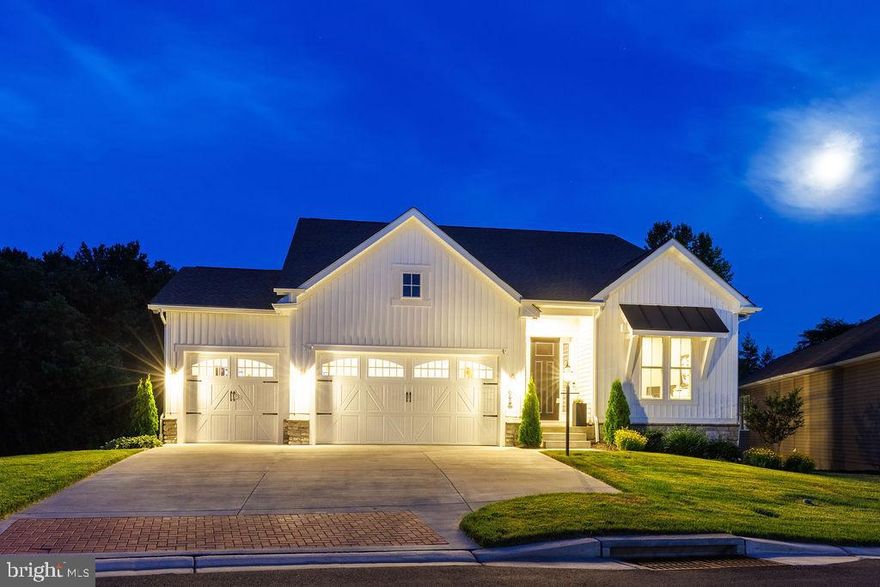 Make sure you check out the virtual tour.  Why buy new construction when you can own a home customized to perfection? This stunning property is the showstopper of Bulle Rock, boasting countless upgrades that make it truly spectacular.

As you drive up to this 4-bedroom, 3.5-bathroom home, its unique appearance (only one of its kind) stands out, thanks to the premium front elevation upgrade and upgraded 3-car garage. Entering the 4,758 square foot home, you'll be greeted by 10' ceilings and a custom oriental runner in the grand entry hall. To the right, a sun-filled office with French doors and motorized Graber window treatments awaits.

Further down the hall, a half bathroom features Quartz counters, an upgraded vanity, a custom mirror, and an elongated toilet. The large laundry room offers Quartz countertops, a sink with an upgraded faucet, extra cabinets, and a smart Samsung washer and dryer. Across the hall, the entry from the garage includes an upgraded drop zone with custom cushions for the bench and a closet.

In the main part of the home, you'll notice the two-story staircase and basement staircase, upgraded to custom oak wood (not even an option the builder had) with a custom stair runner. Additional details include 5-inch baseboards, crown molding, 5-inch cased openings, and LVP flooring. The elegant dining room features tray ceilings and deluxe picture frame wood trim wainscoting. The butler's pantry offers upgraded glass front cabinets, Quartz countertops, a sink, a beverage center, and a massive walk-in pantry.

The gourmet chef's kitchen is exceptional, with every upgrade imaginable: GE Café appliances, a pot filler, a gas range, Quartz counters, custom tile to the ceiling at the range hood, upgraded hardware, a farmhouse sink, and a touch sensor faucet. The kitchen flows seamlessly into the great room with tray ceilings, an upgraded gas fireplace, a stone surround, and a wrapped mantle. Off the kitchen, the sunroom/breakfast room with vaulted ceilings leads to the extended covered porch, where ceiling fans keep you cool as you enjoy the peaceful wooded backyard.

The main floor also features the stunning primary suite, with tray ceilings, a custom accent wall, a custom rug, and an extended layout. The primary bathroom offers Quartz counters, a dual vanity, custom mirrors, pendant lights, upgraded fixtures, a shower with custom tile, seamless glass doors, and a waterfall showerhead. The walk-in closet includes a custom organizer by The Container Store.

Upstairs, there are two bedrooms with walk-in closets and a large hall bathroom with Quartz countertops and upgraded fixtures. The walk-out basement is an entertainer’s dream, with natural light, a rec room, a kitchenette, a full bar, a gym with a walk-in closet (or flex room), a full bathroom with upgraded tile, and a bedroom with a walk-in closet. The layout makes an in-law suite possible, and the basement also offers several walk-in closets for storage and potential craft rooms. A tankless water heater and additional storage in the utility room are added bonuses.

Outside, the magazine-worthy exterior hardscaping includes a covered patio, an outdoor kitchen, a wood-fired pizza oven, and a fire pit with additional seating. This home’s premium lot offers a private retreat, enhanced by fully stone skirting, an underground sprinkler system, a whole-house generator, custom stone stairs, extensive landscaping, and lighting.

This one-of-a-kind home offers more custom features than any other home in the community and must be seen to be believed. Don’t miss your chance to own this spectacular masterpiece in Bulle Rock. Schedule a showing today!