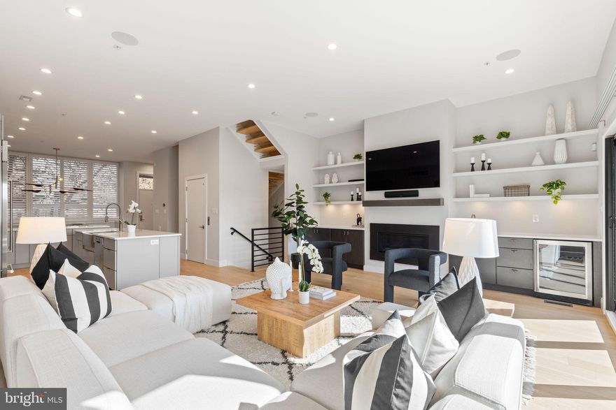 Luxury nearly new construction in the heart of Manayunk- 4584 Silverwood is a stunning townhome that offers ample spaces to enjoy everyday living and easy entertaining. Designed with 11 ft tall ceiling and at 20 ft wide, this home stands out a. The 20 ft width offers ample spaces for you to enjoy and entertain in, and the soaring 11 ft tall ceilings add to the open and airy feel. The five stop elevator is the ultimate in convenience. Pull into your two car garage, and enter into a flex space in the lower level- perfect for an office, workout room, or playroom. The chef’s kitchen is an entertainer’s dream, featuring wolf and sub zero appliances with a steam oven, quartz counters, and modern flat panel cabinetry. The living room is spacious yet cozy, with a linear gas fireplace, open shelving, and a wet bar with beverage center. La cantina doors lead out onto the patio that features a retractable awning. The primary suite spans the entire third floor, featuring two walk in closets, a very spacious primary bathroom with dual vanities, luxurious soaking tub, Porcelanosa tile, two water closets, and a Juliet balcony. The fourth floor has three additional bedrooms and two full bathrooms. The top floor has a second wet bar for easy entertaining and access to the rooftop deck with jacuzzi. The roof deck is landscaped with a low maintenance succulent garden that regrows each year. Stunning views from atop the hill are yet another highlight. This home is perfect for the buyer who wants the ultimate in luxury, urban living, and easy access to the suburbs and main line. Bonus- 5 years left on the tax abatement!