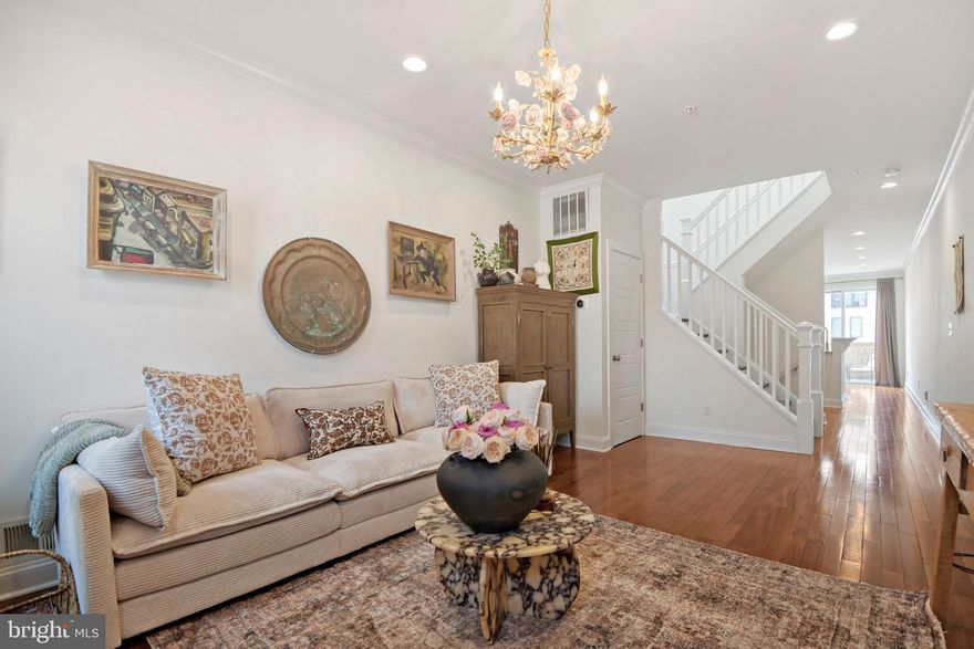 Welcome to 3858 Quarry Ave, a beautifully updated home in the heart of Hampden, offering nearly 1,800 square feet of thoughtfully designed living space across three finished levels. Complete with a private parking pad, this home blends modern convenience with one-of-a-kind custom details. Step inside to find tall ceilings, rich wood flooring, recessed lighting, and fresh paint throughout. The main level is both stylish and functional, featuring a stunning kitchen with white cabinetry, stainless steel appliances, and gas chefs stove. Elegant Calacatta Monet marble countertops imported from Italy elevate the space, while a dedicated dining area flows seamlessly to the rear deck perfect for morning coffee or evening gatherings. Upstairs, the primary suite offers a luxurious retreat with a spa-like bathroom, including a double vanity and oversized shower. A second bedroom and full bath complete this level. Throughout the home, you’ll find unique artistic touches, including hand-painted murals in two bedrooms and a custom stained glass transom window above the front door. The living room is anchored by a striking handmade chandelier sourced from Milan, adding a distinctive designer element. The fully finished lower level provides a versatile third bedroom, third full bath, and a separate laundry room, along with access to a fully fenced backyard ideal for entertaining or relaxing outdoors. Located just steps from all that Hampden has to offer renowned restaurants, charming cafes, and boutique shopping with easy access to I-83 and major commuter routes.